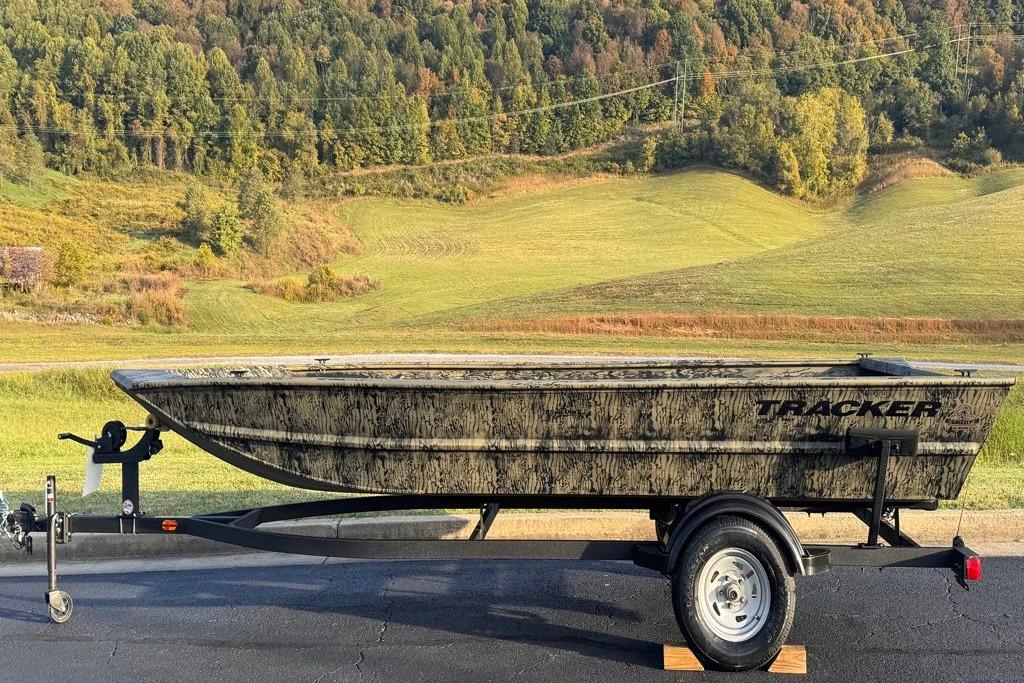 2026 Tracker Grizzly 1754 Utility boat on trailer, set against a scenic countryside backdrop.