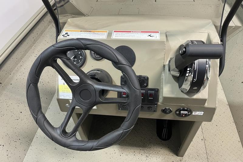 2025 SeaArk Shadow 18T boat console with steering wheel and controls.