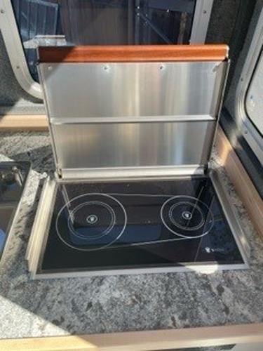 2025 Spartan 2600 Olympia RV kitchen with modern induction cooktop and sleek countertop design.