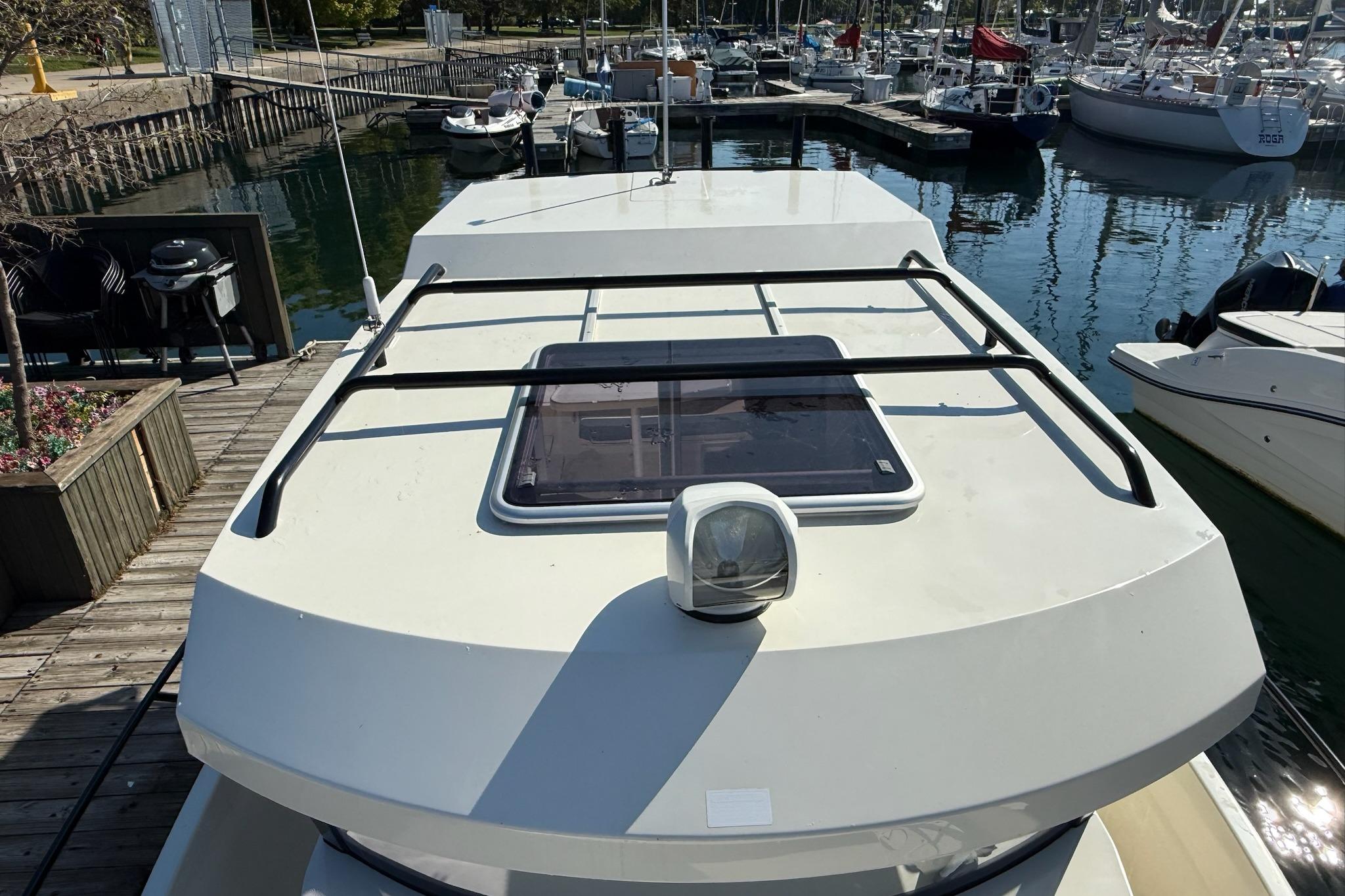 2024 Bayliner Trophy T25 Pilothouse docked at marina, top view.