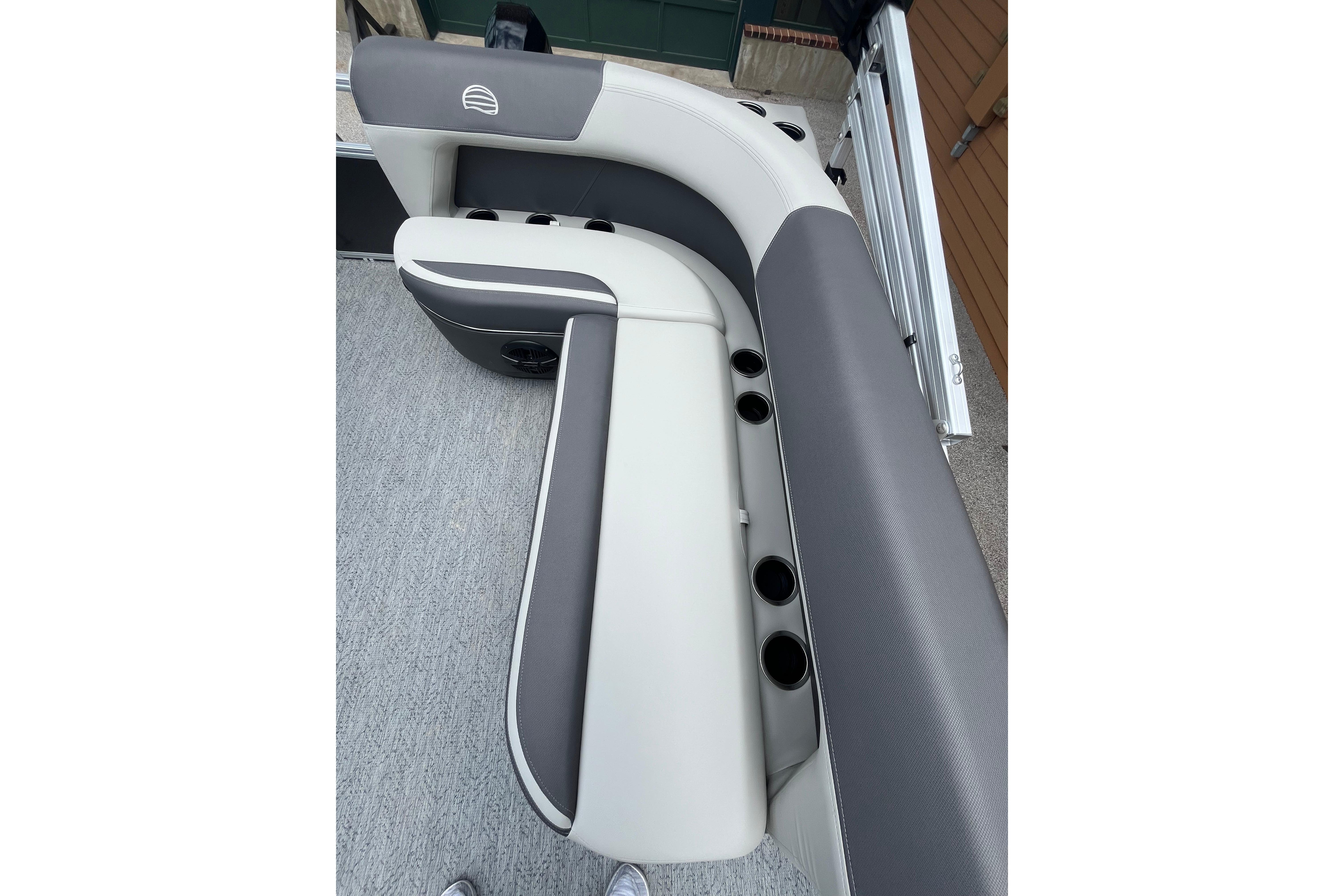 2026 Sun Tracker Bass Buggy 16 XL Select boat seating with cup holders, gray and white upholstery.