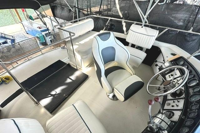 1989 Carver 32 Aft Cabin Motor Yacht helm with seating and steering wheel.