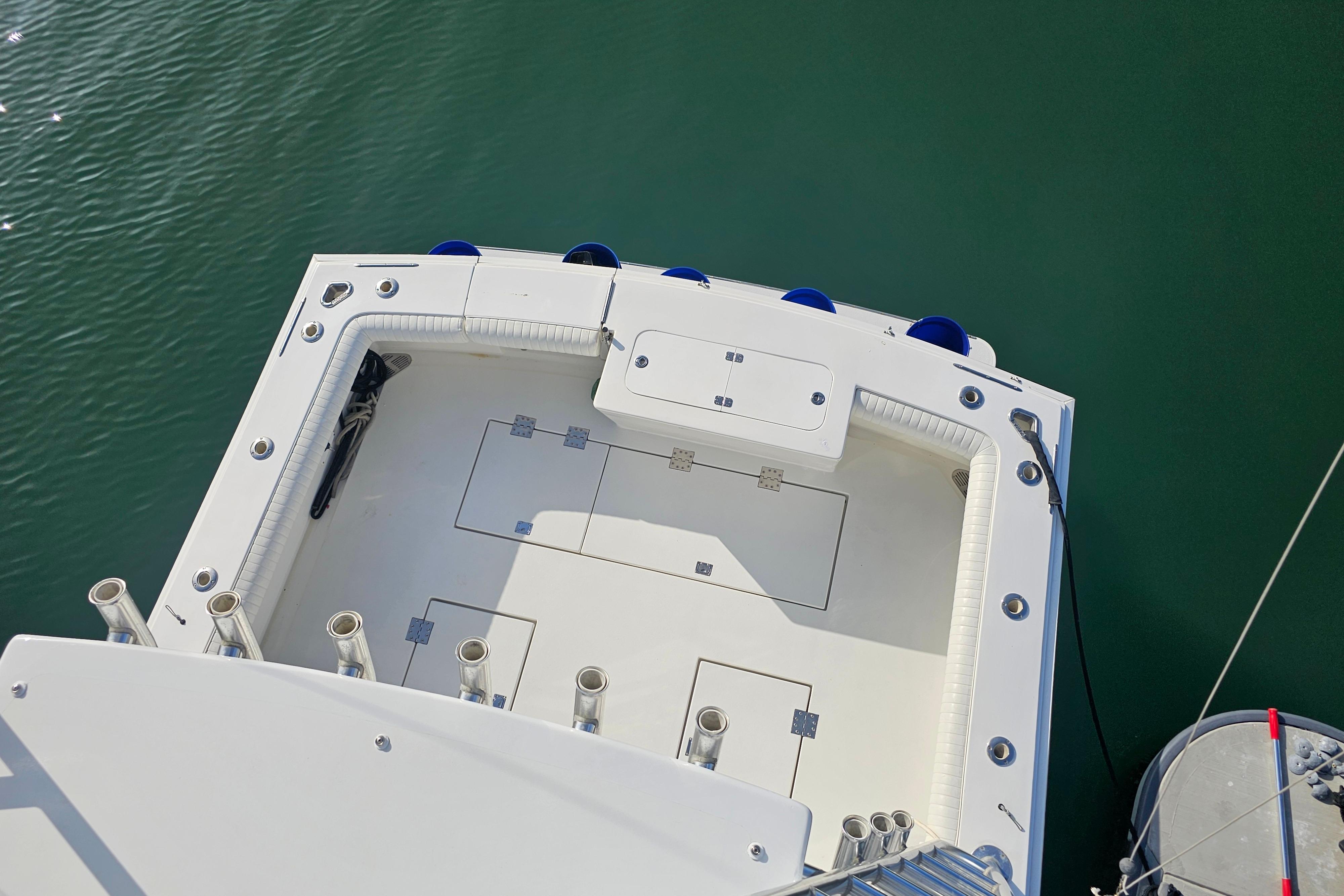 Top view of 2003 Topaz 32 Express boat deck, featuring rod holders and storage compartments.