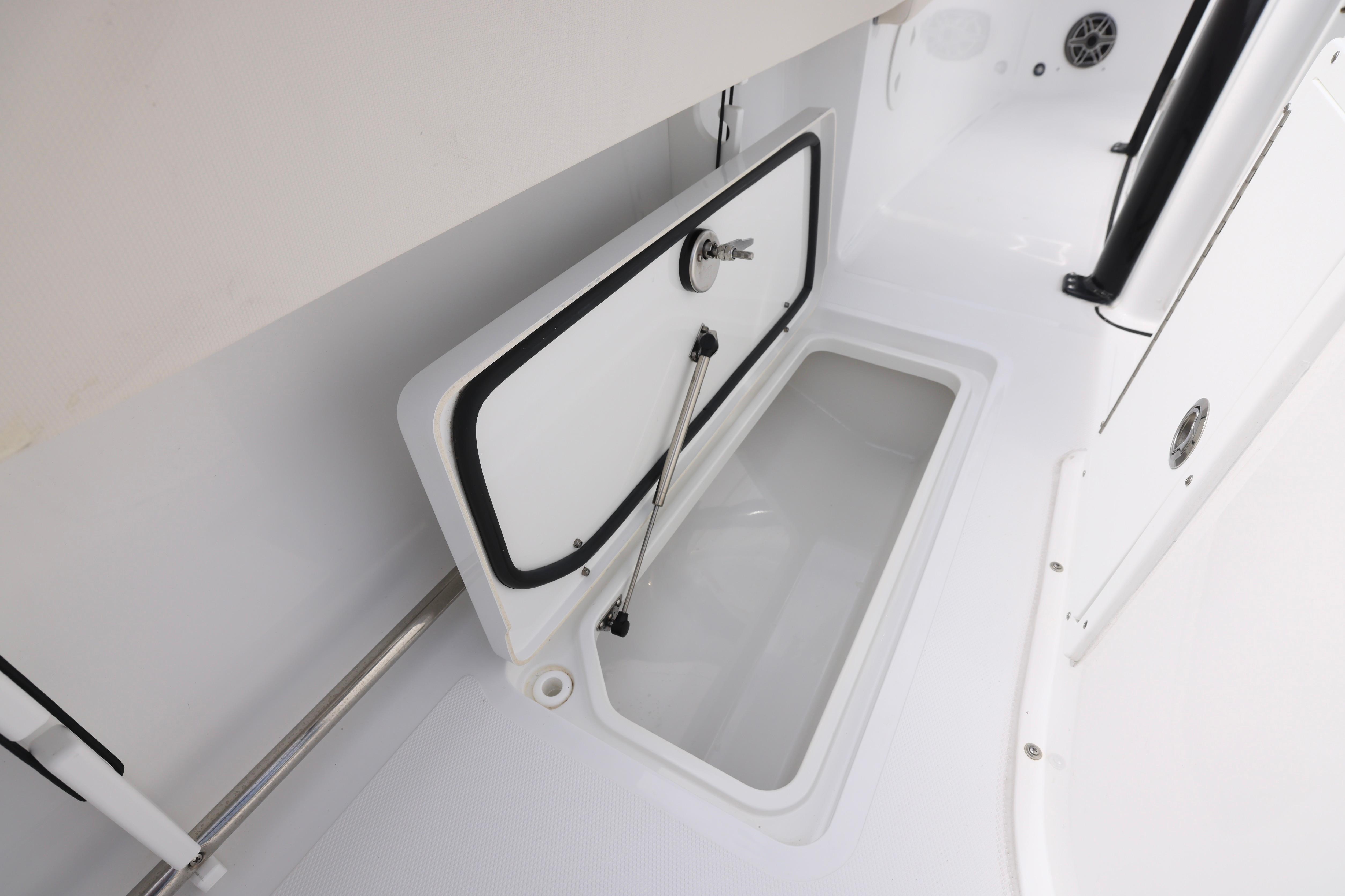 2026 Sea Hunt Gamefish 25 boat storage compartment, open and empty.