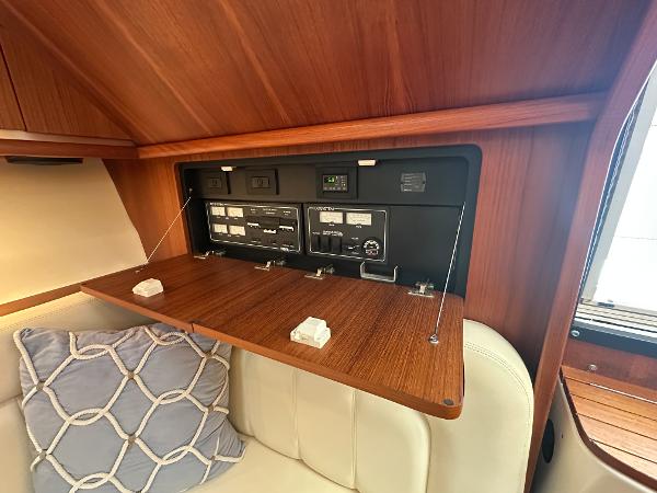 2006 Tiara Yachts 3200 Open cabin with control panel and cushioned seating.