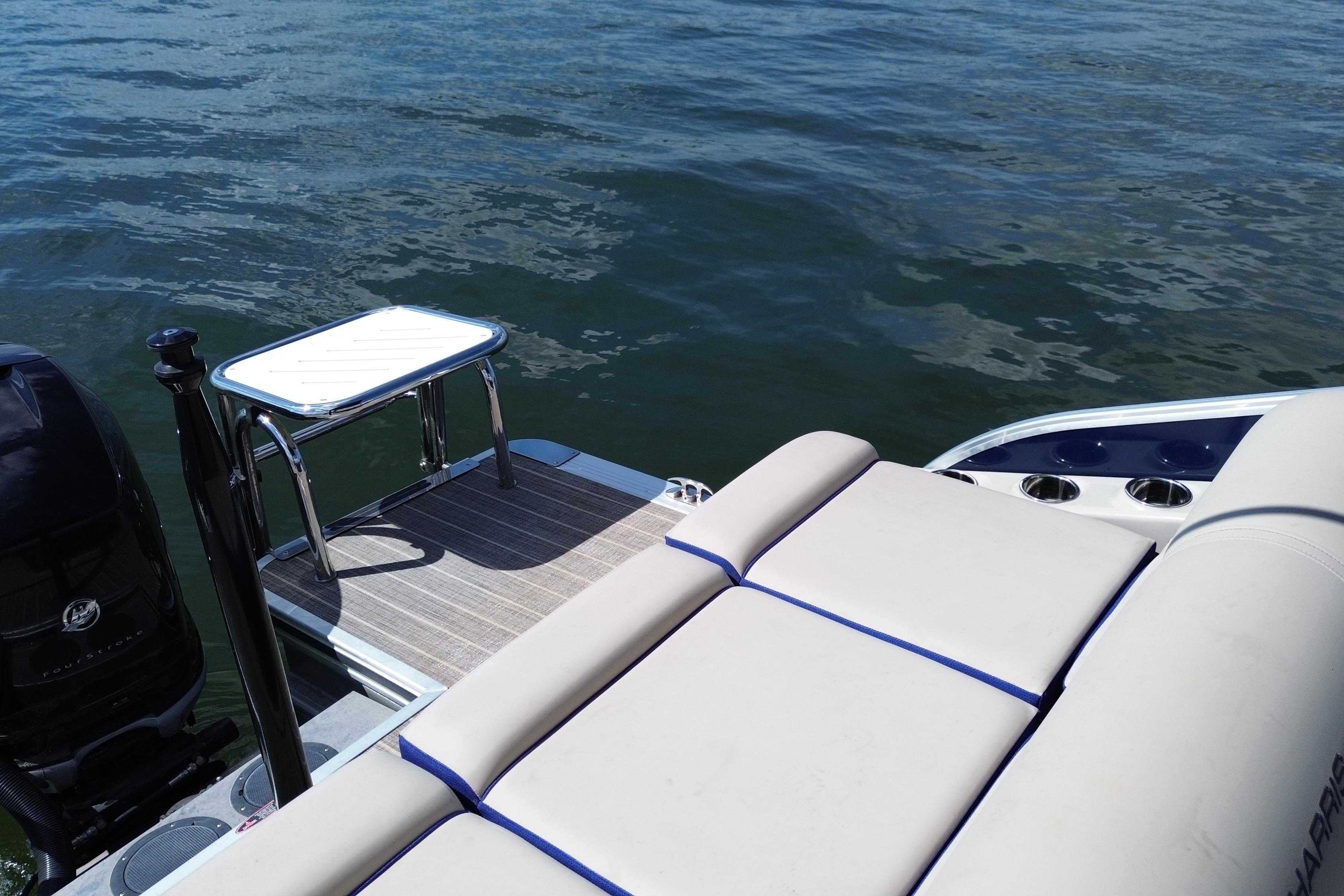 2022 Harris Grand Mariner 250 boat with seating and swim platform on water.