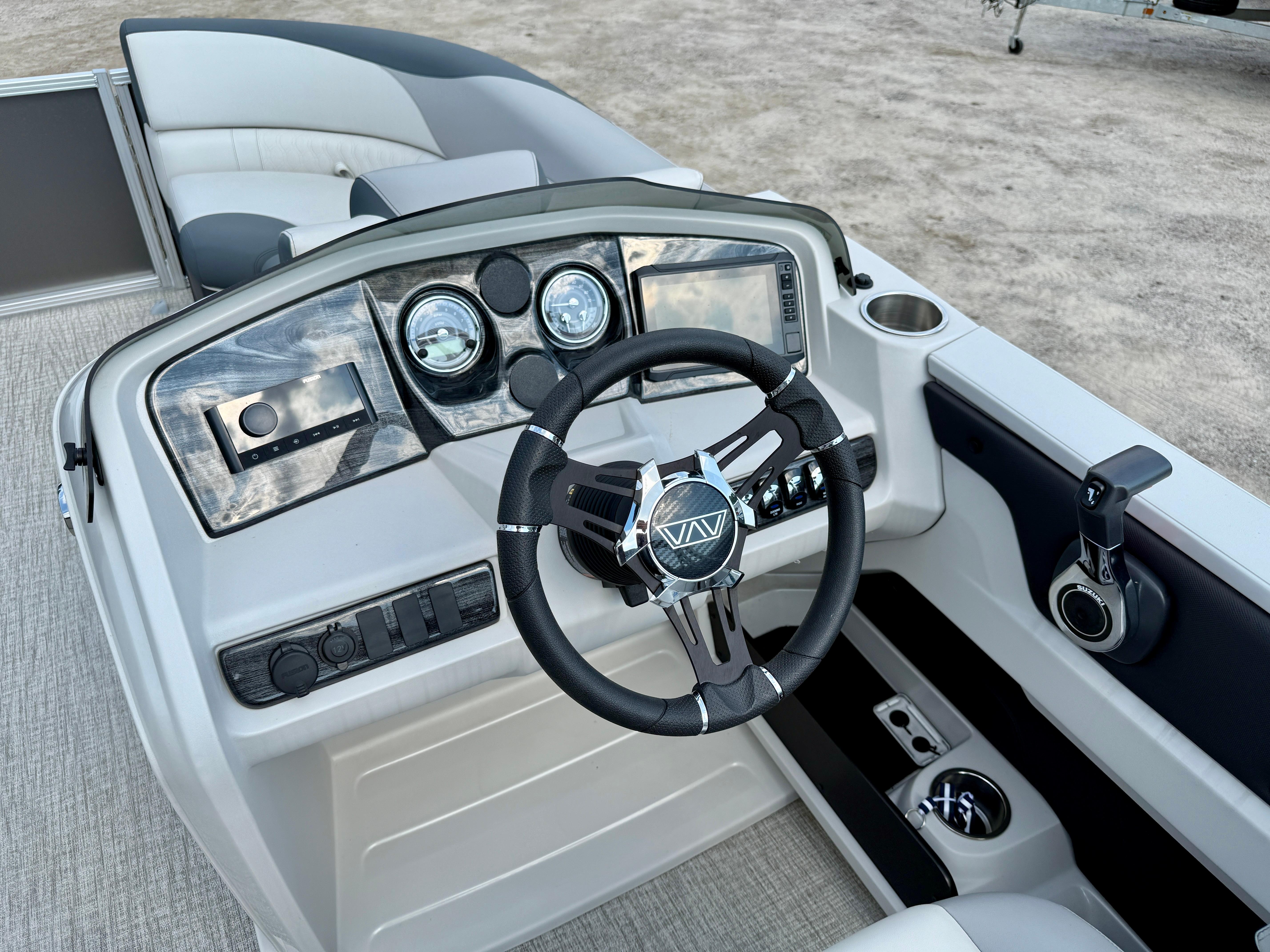 2025 Avalon LSZ Cruise Rear Bench boat dashboard with steering wheel and control panel.