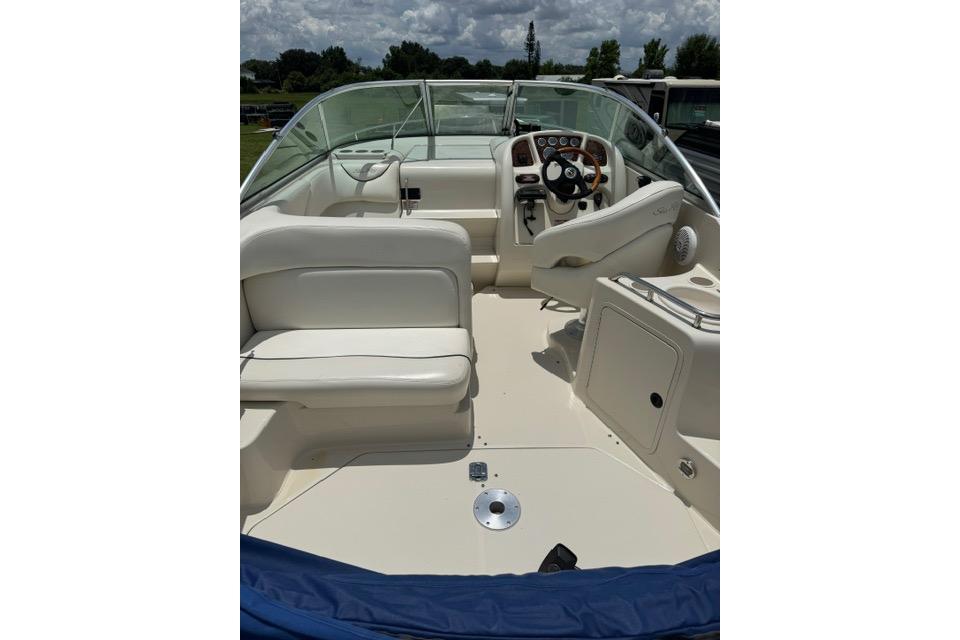 2004 Sea Ray 240 Sundancer boat interior with steering wheel and seating.