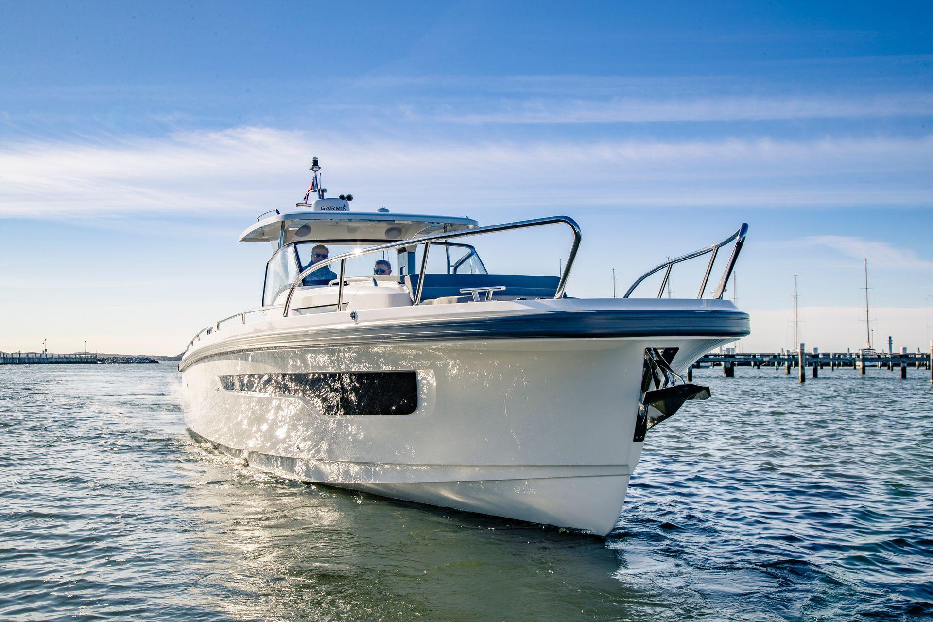 2024 Nimbus Tender 11 boat cruising on calm waters under a clear blue sky.