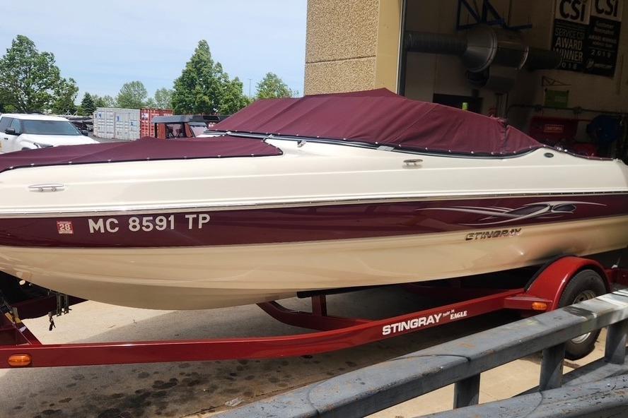 2013 Stingray 198 LX boat with maroon cover on a trailer.