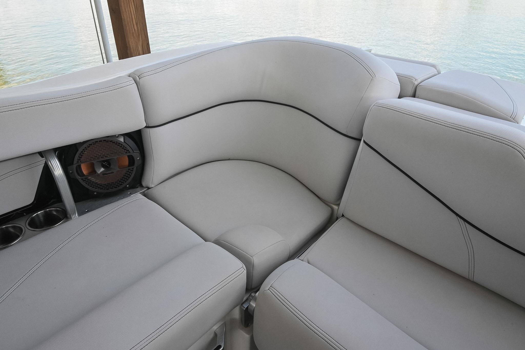 Luxurious seating on 2018 MasterCraft X23 boat with cup holders and speaker.