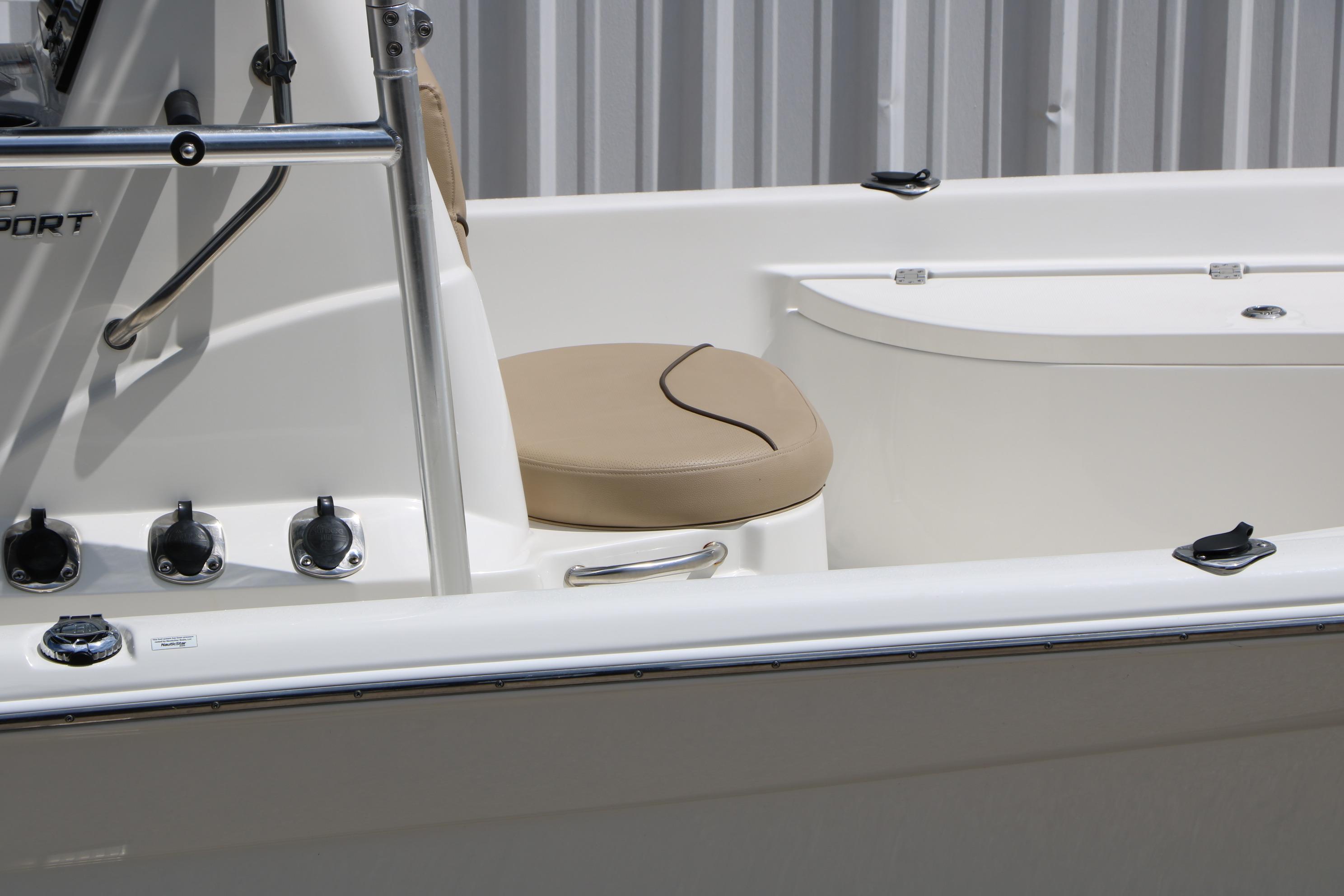 2020 NauticStar 2140 Sport boat interior with beige seating and control panel.