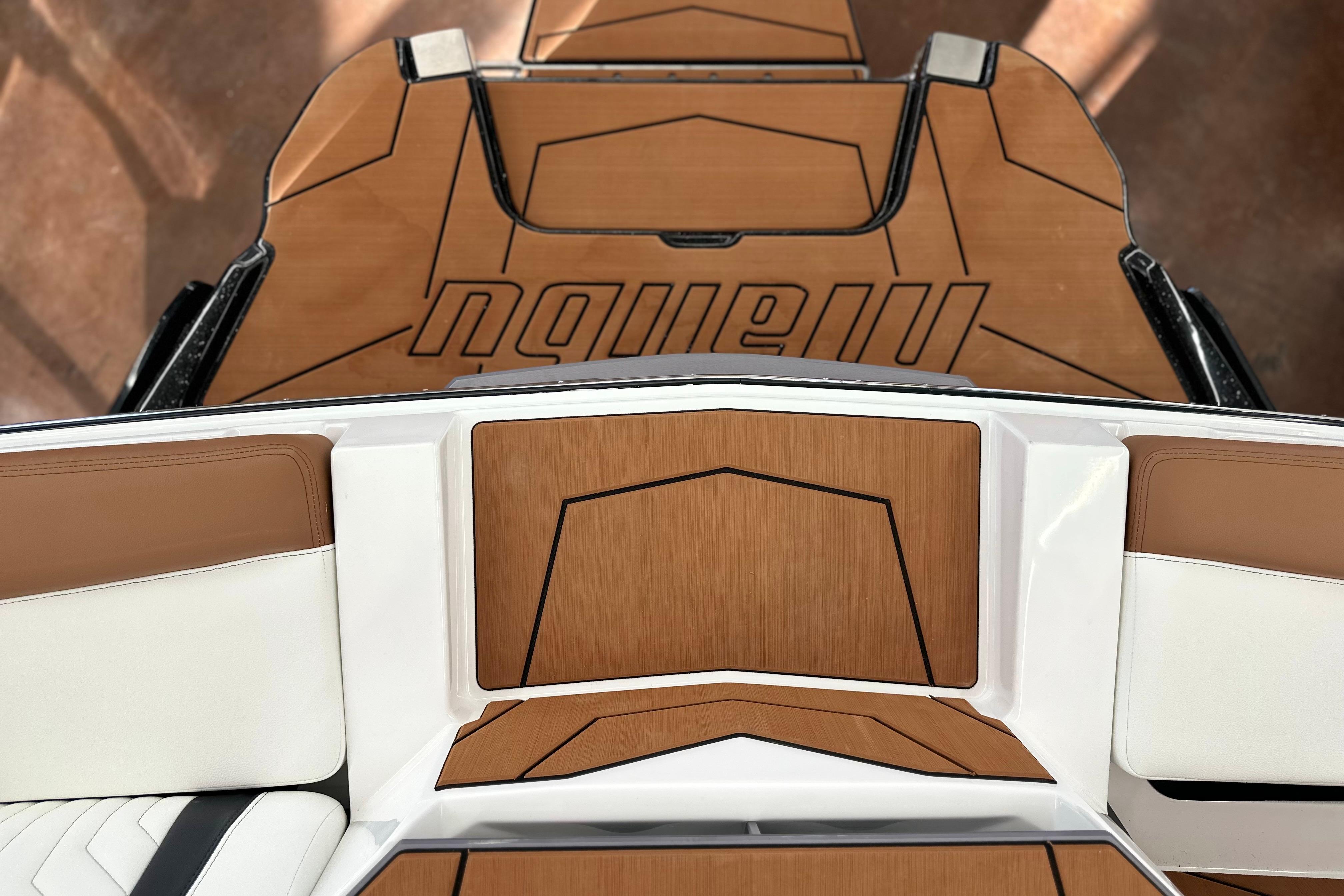 2026 Malibu Wakesetter 25 LSV boat interior with sleek brown and white seating design.