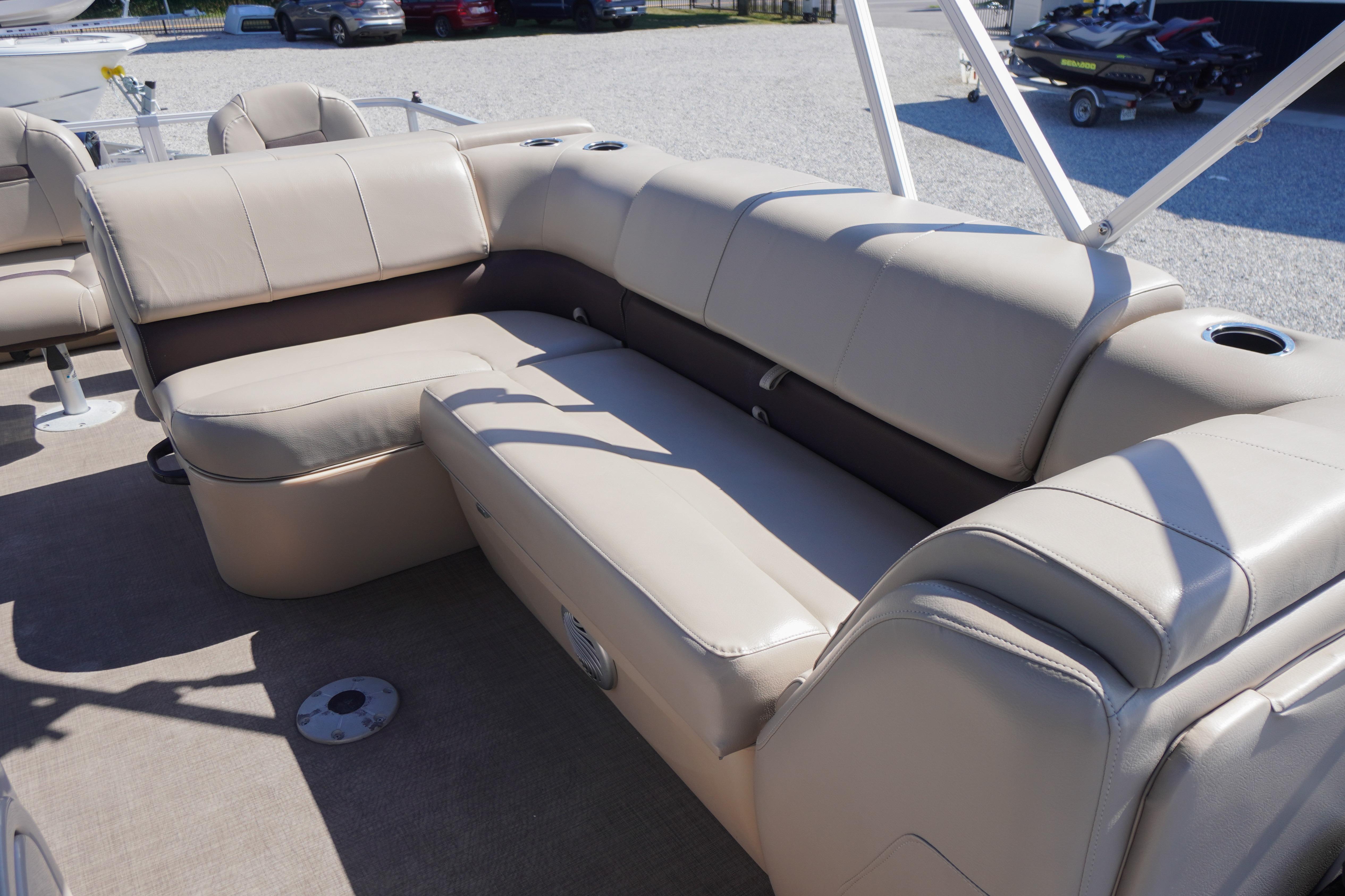 2019 SUNTRACKER Fishin' Barge 22 DLX with beige seating and cup holders on deck.