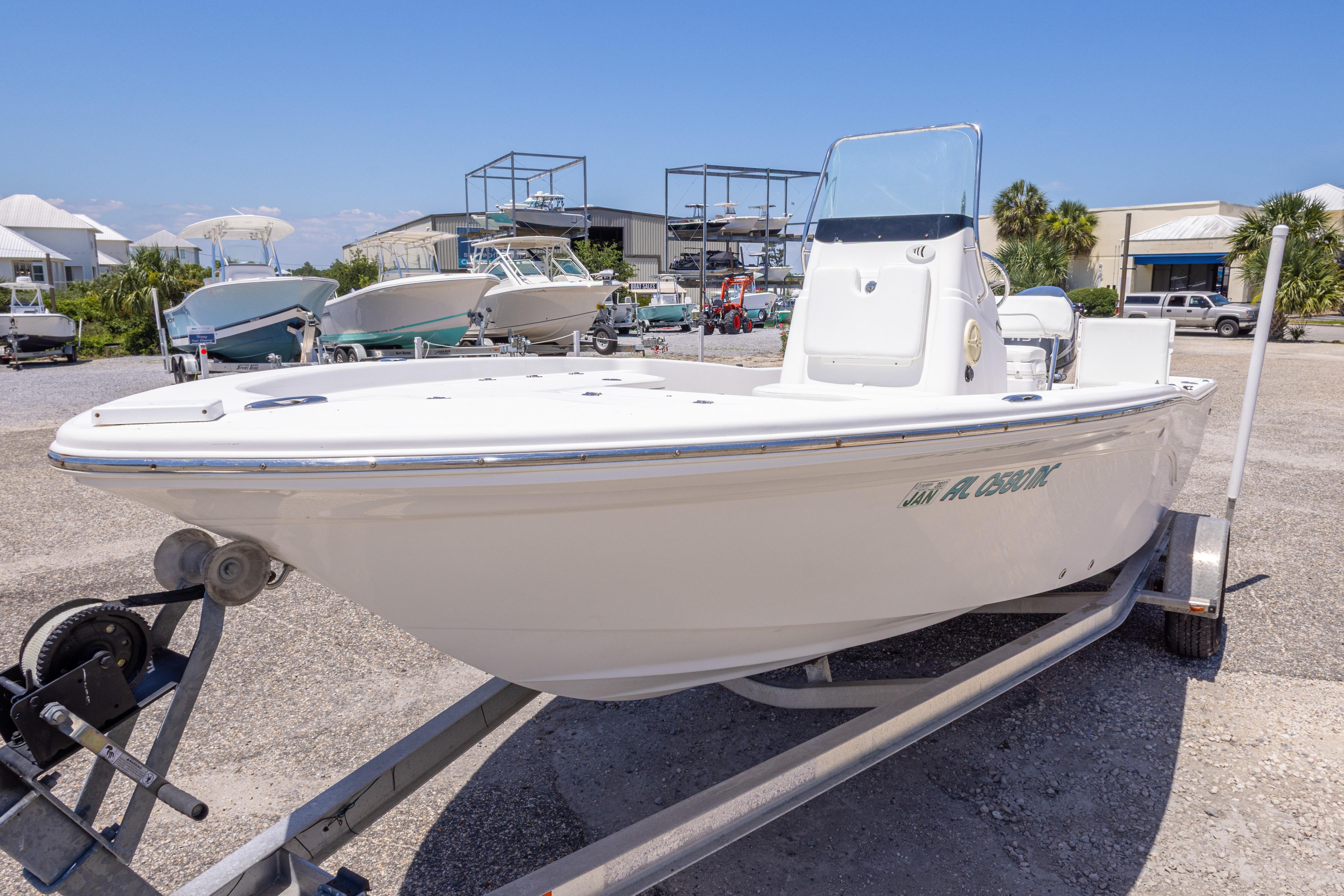 2011 Sea Fox 200XT boat on trailer in marina setting, clear sky background.