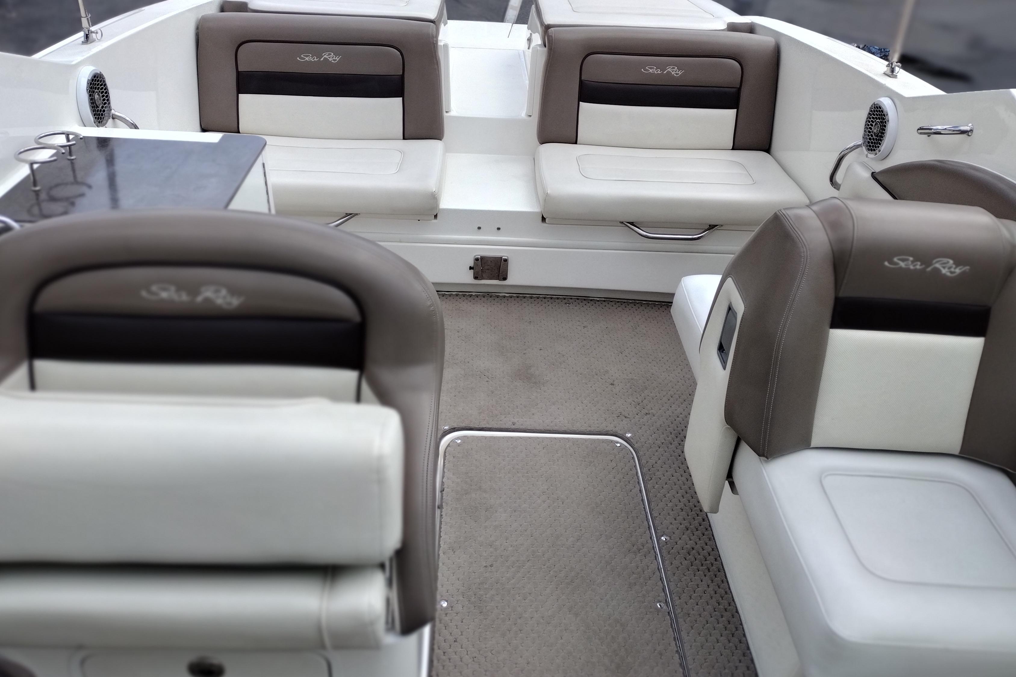 Interior of a 2013 Sea Ray 300 SLX boat with cushioned seating and carpeted flooring.