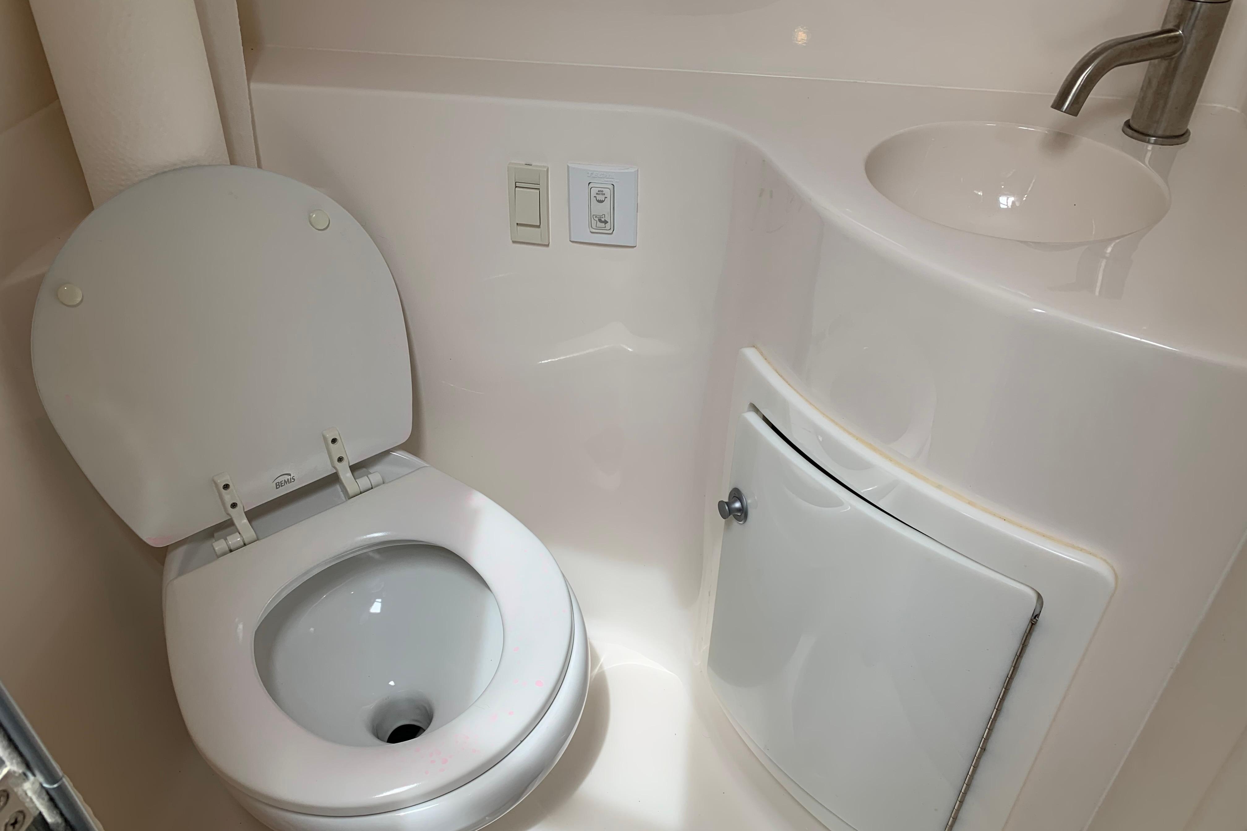 2017 Regal 26 Express boat bathroom with toilet and compact sink.