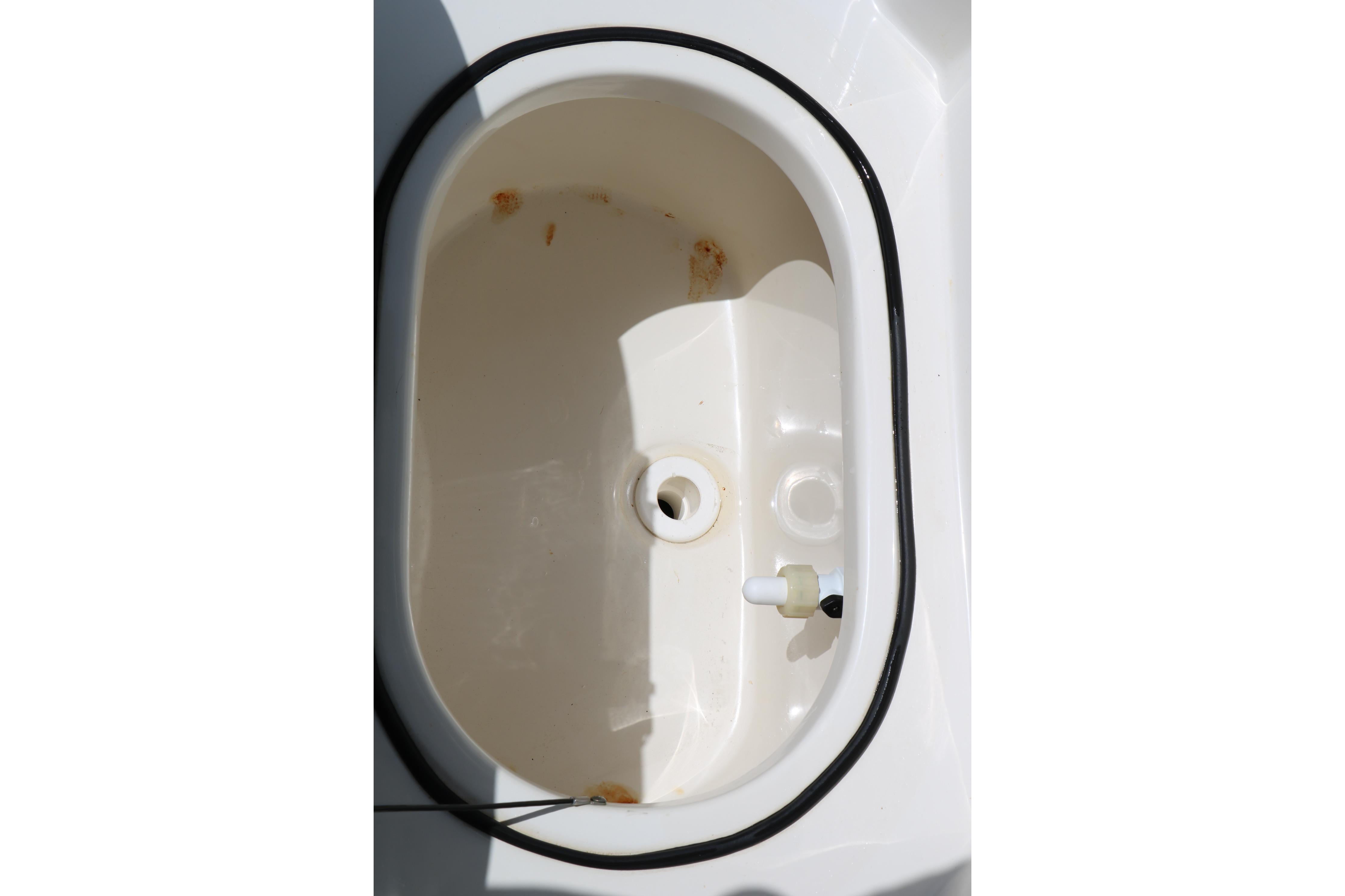 Livewell compartment of 2020 NauticStar 2140 Sport boat, featuring a clean, oval design.