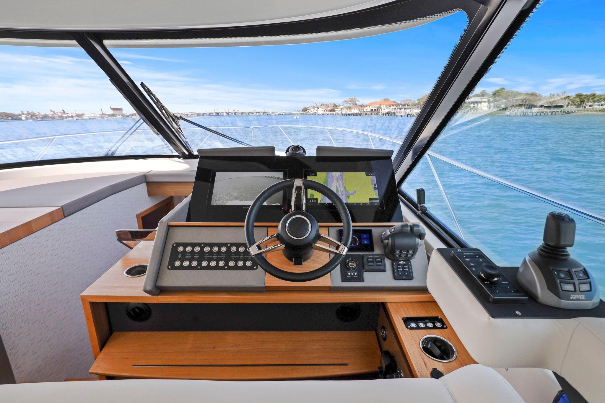 2023 Tiara Yachts C49 Coupe helm with advanced navigation systems and scenic ocean view.