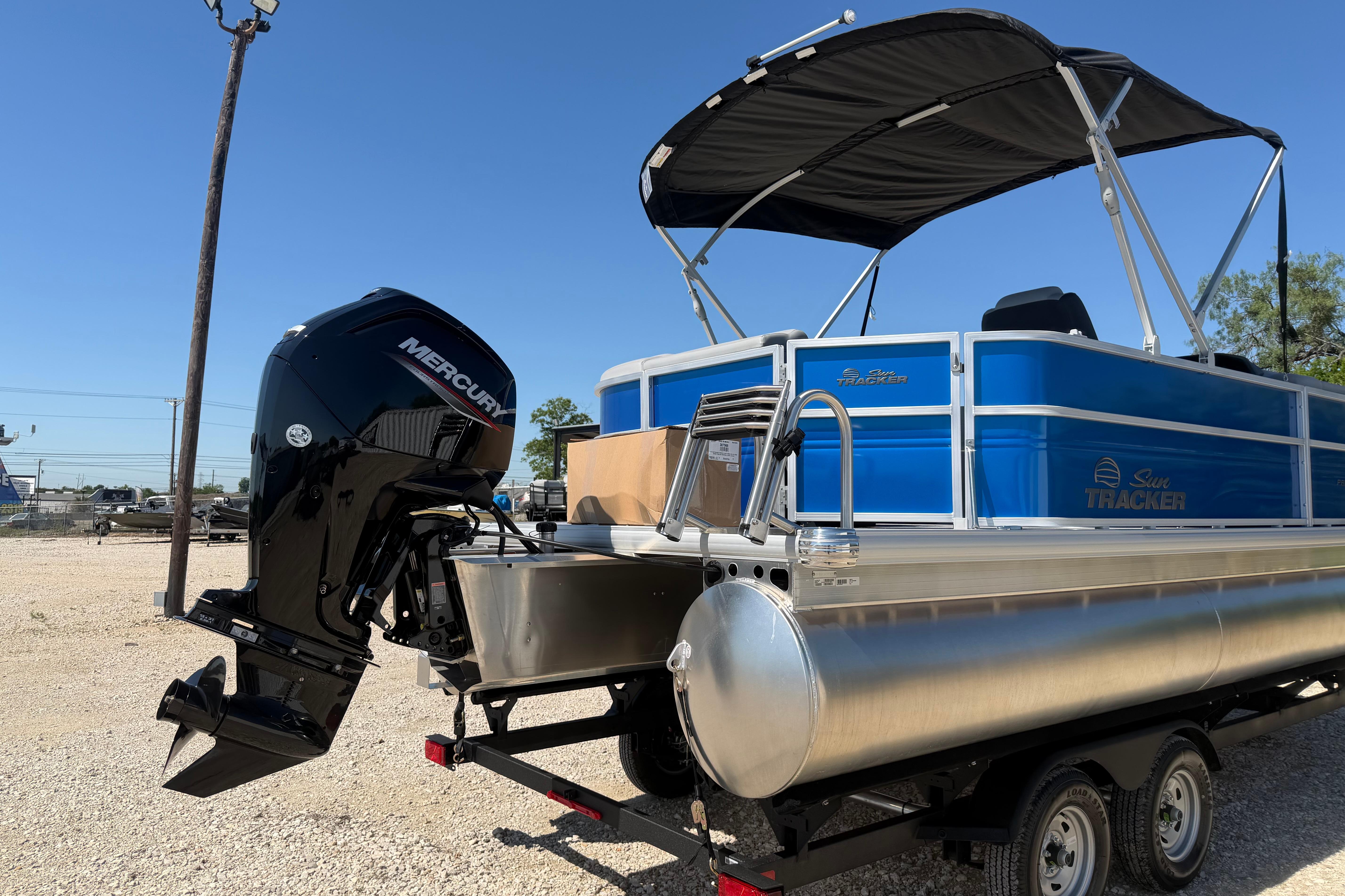 2026 Sun Tracker Party Barge 20 DLX pontoon boat with Mercury outboard motor.