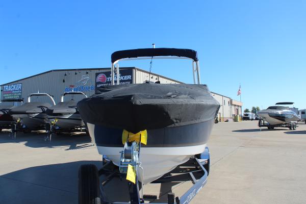 2025 Cobalt CS23 boat with cover in marina parking lot.