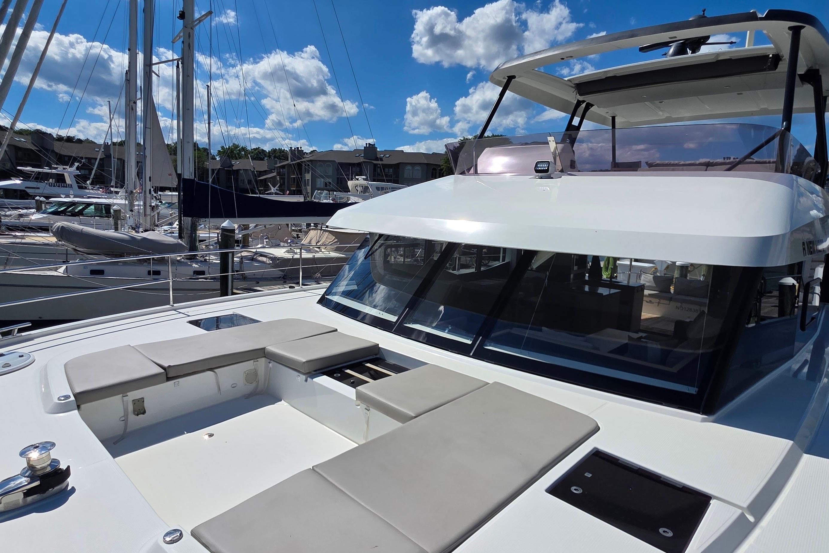 2018 Fountaine Pajot Motor Yacht 44 docked, showcasing sleek design and spacious deck seating.
