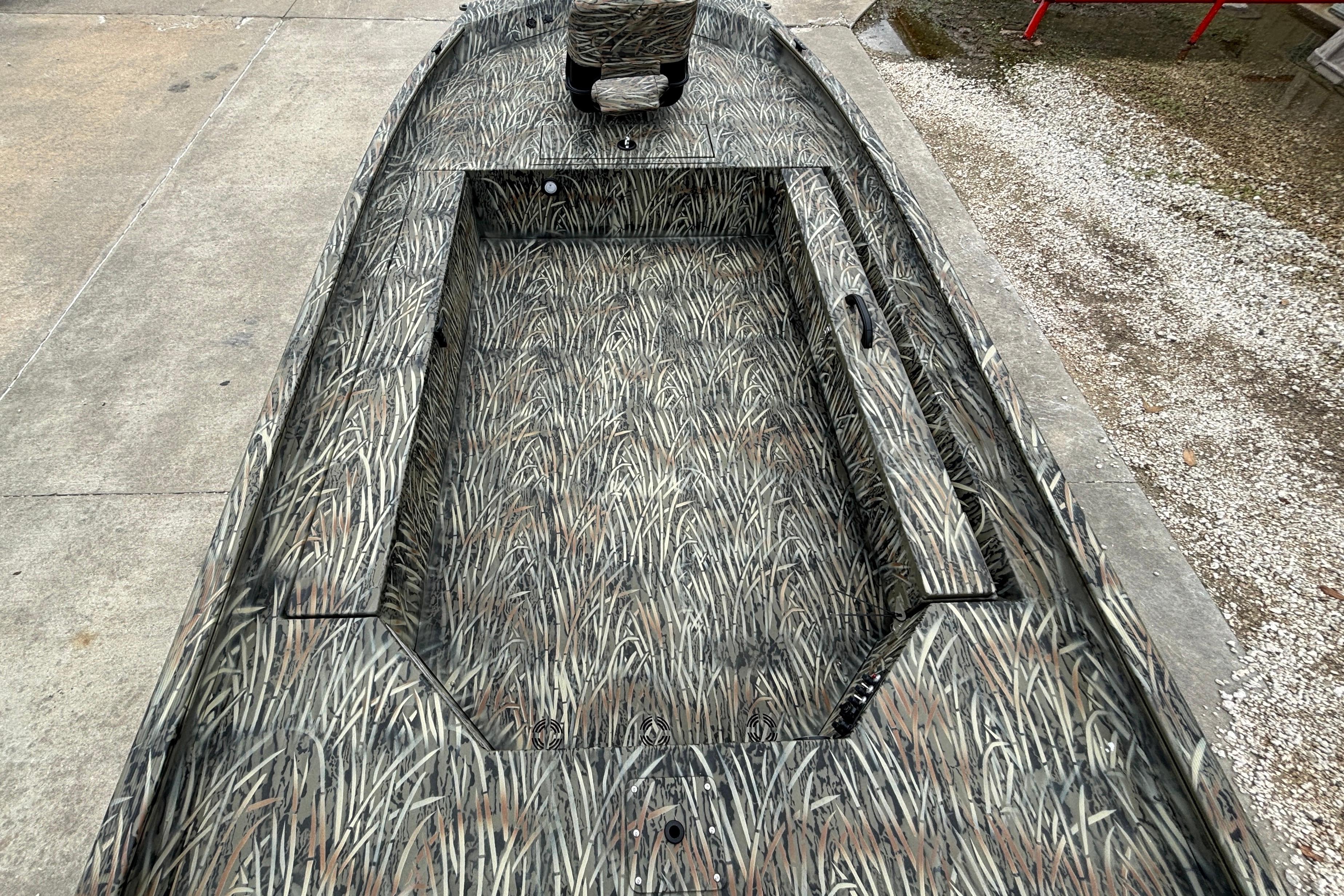 2026 Tracker Grizzly 1654 T Sportsman boat with camouflage interior design.