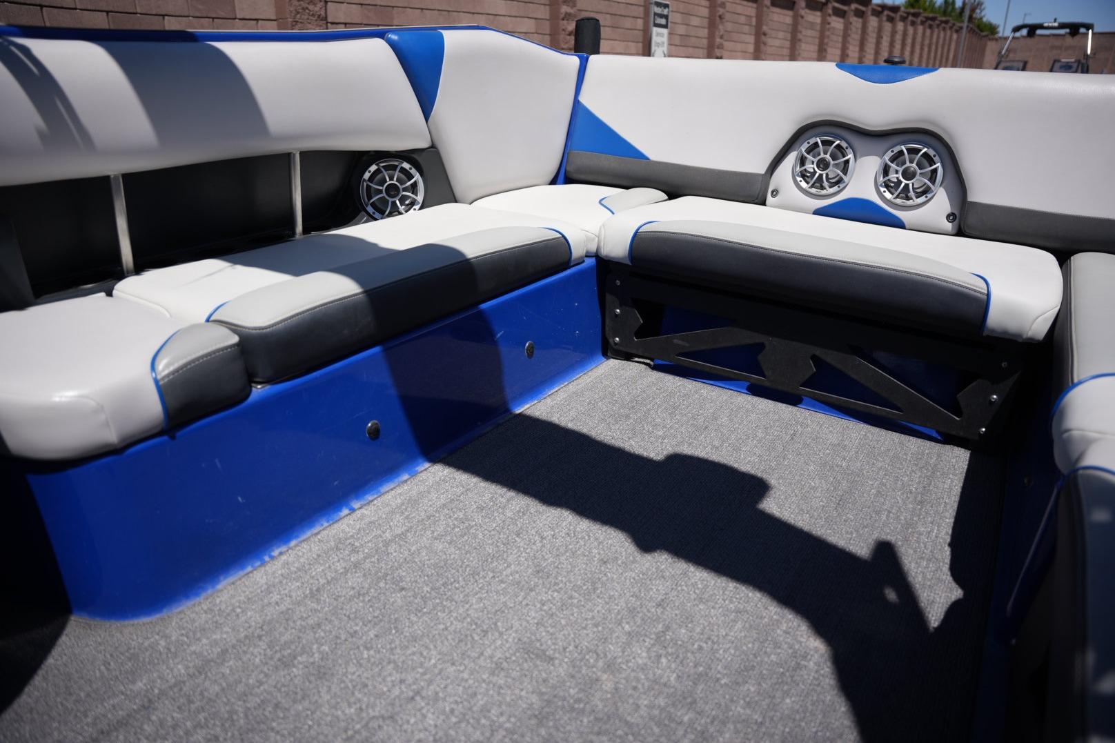 Interior of a 2015 Axis A24 boat with blue and gray seating.