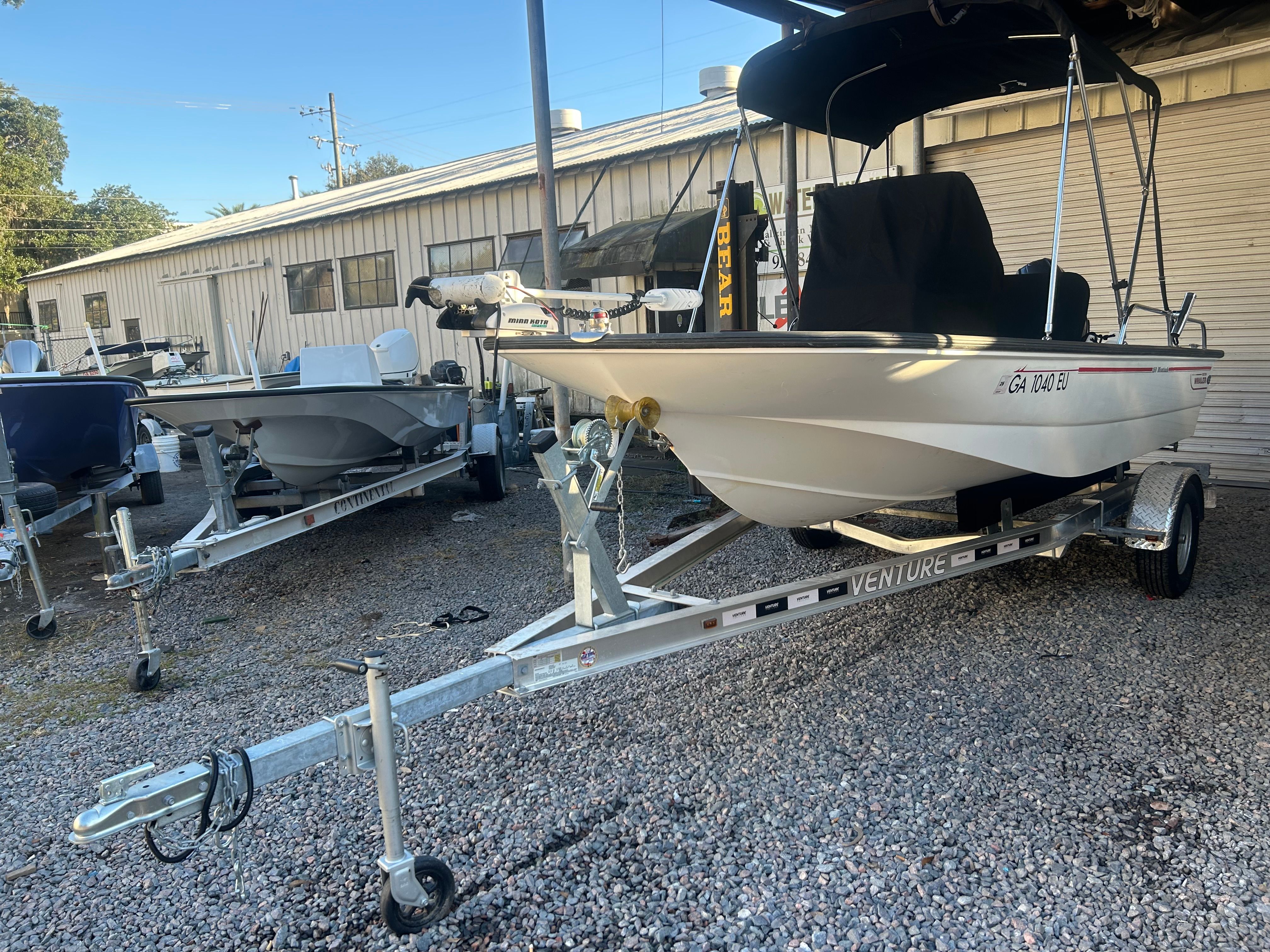 2006 Boston Whaler 150 Montauk on trailer parked outdoors.