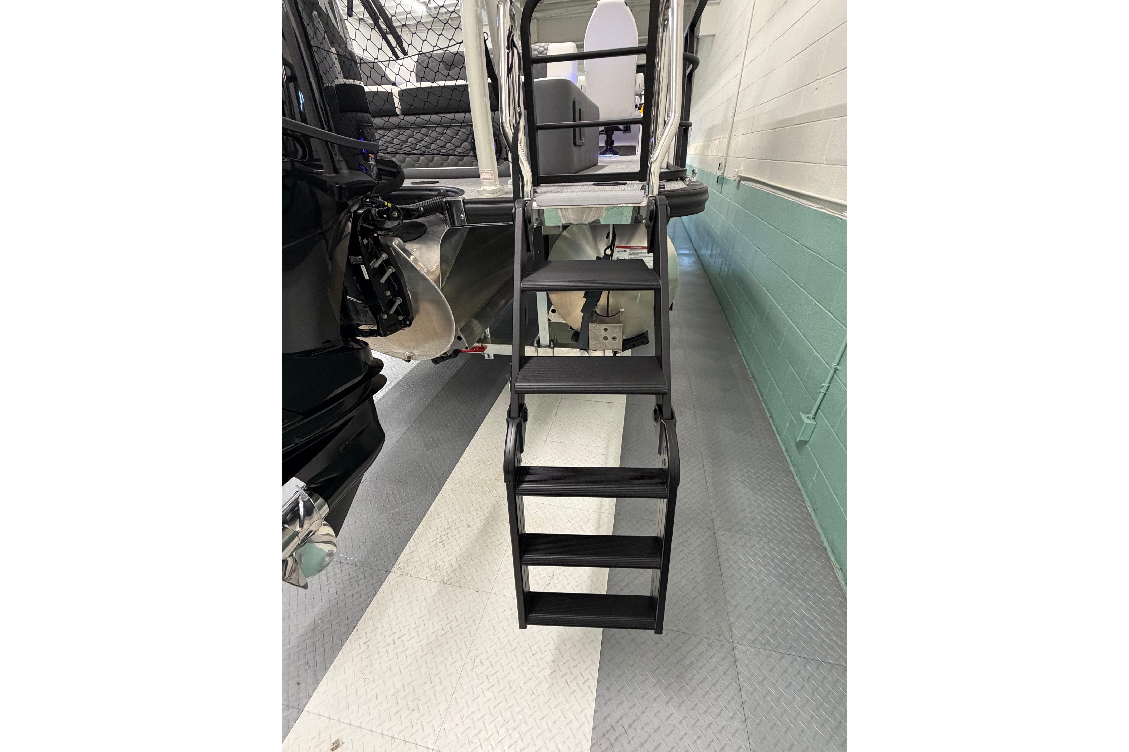 Staircase leading to South Bay 525SB2 boat interior, 2026 model, in a showroom.