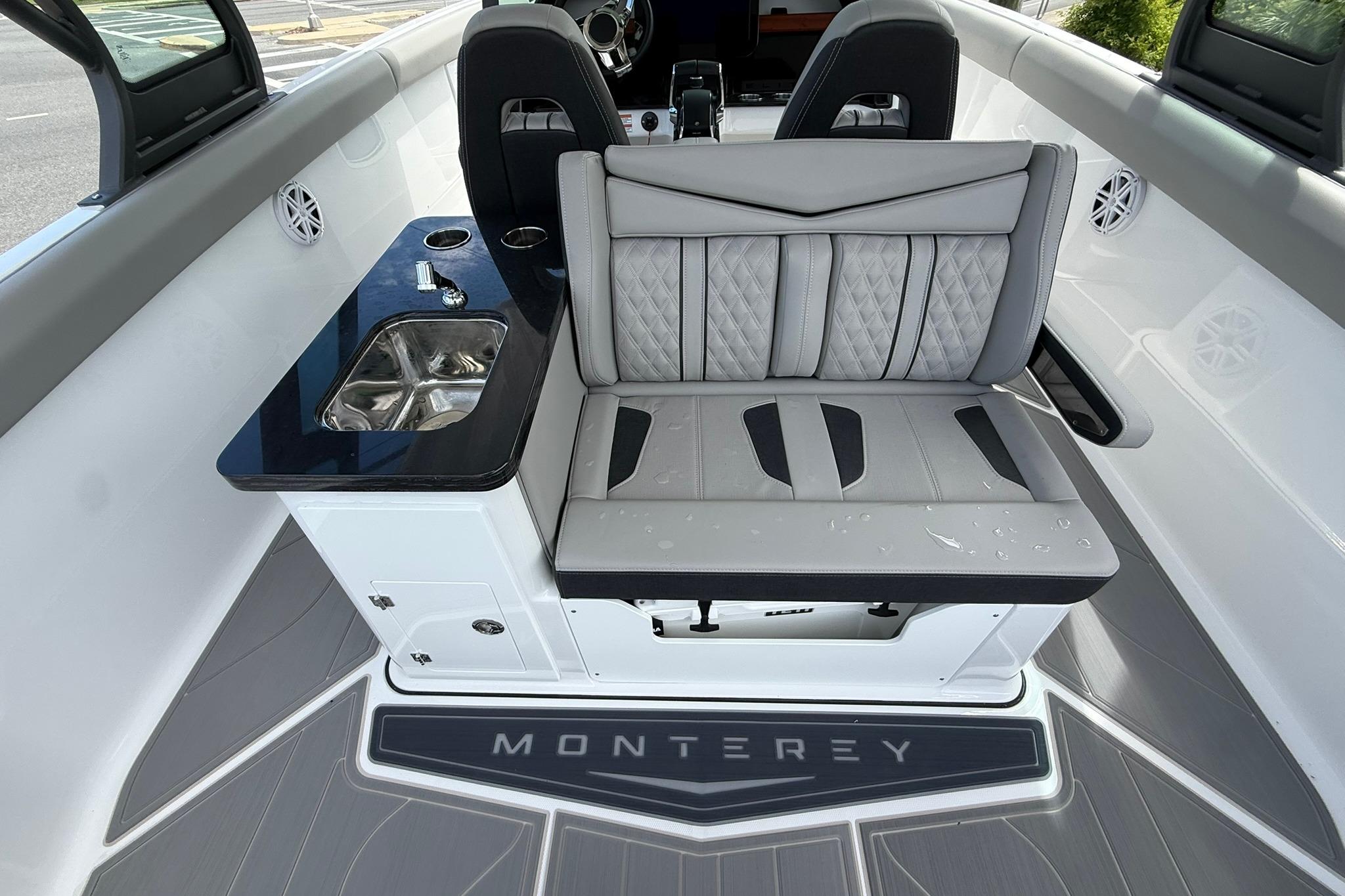 Interior of 2027 Monterey Elite 30 OB boat with seating and sink area.