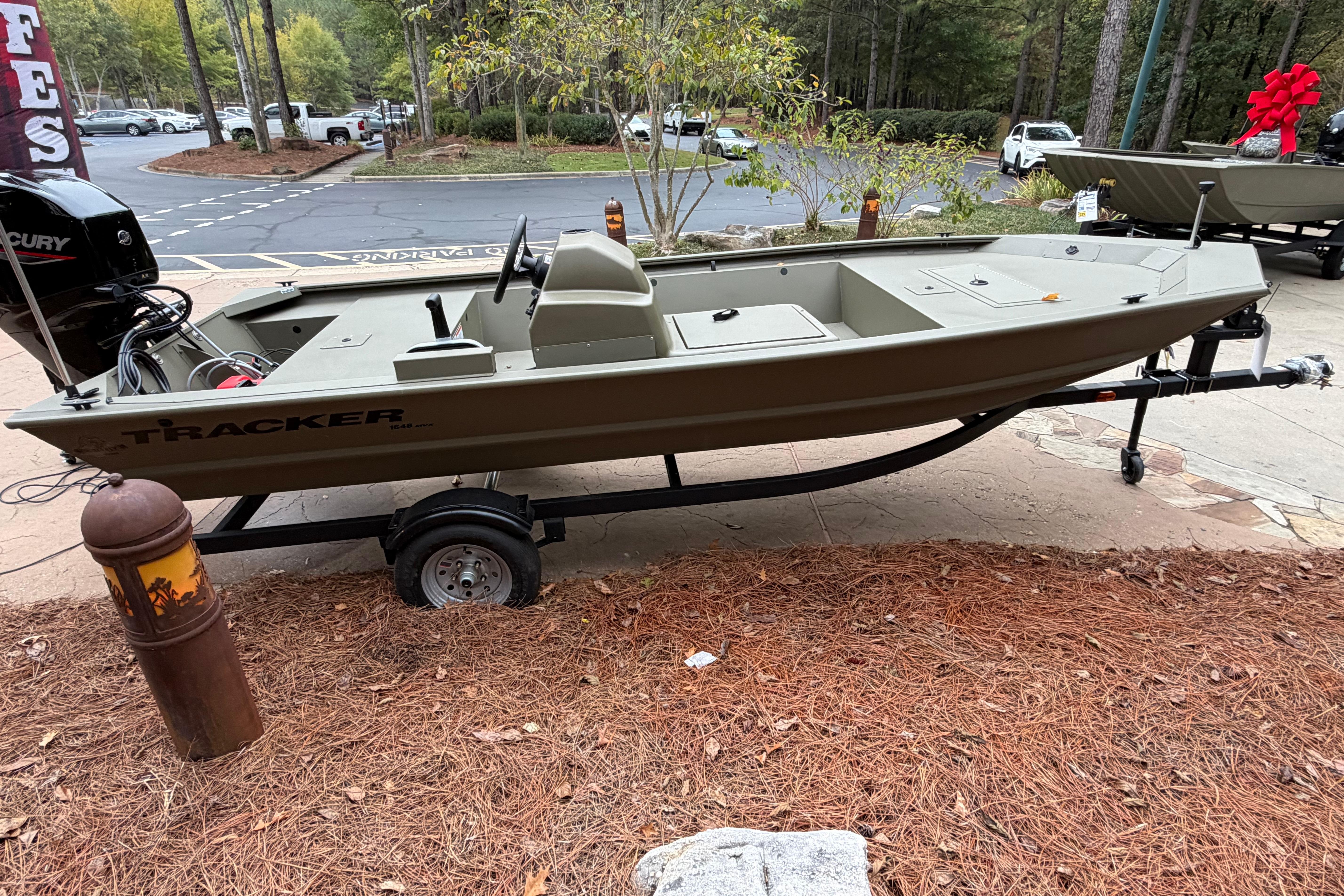 2026 Tracker Grizzly 1648 SC boat on trailer in outdoor setting.