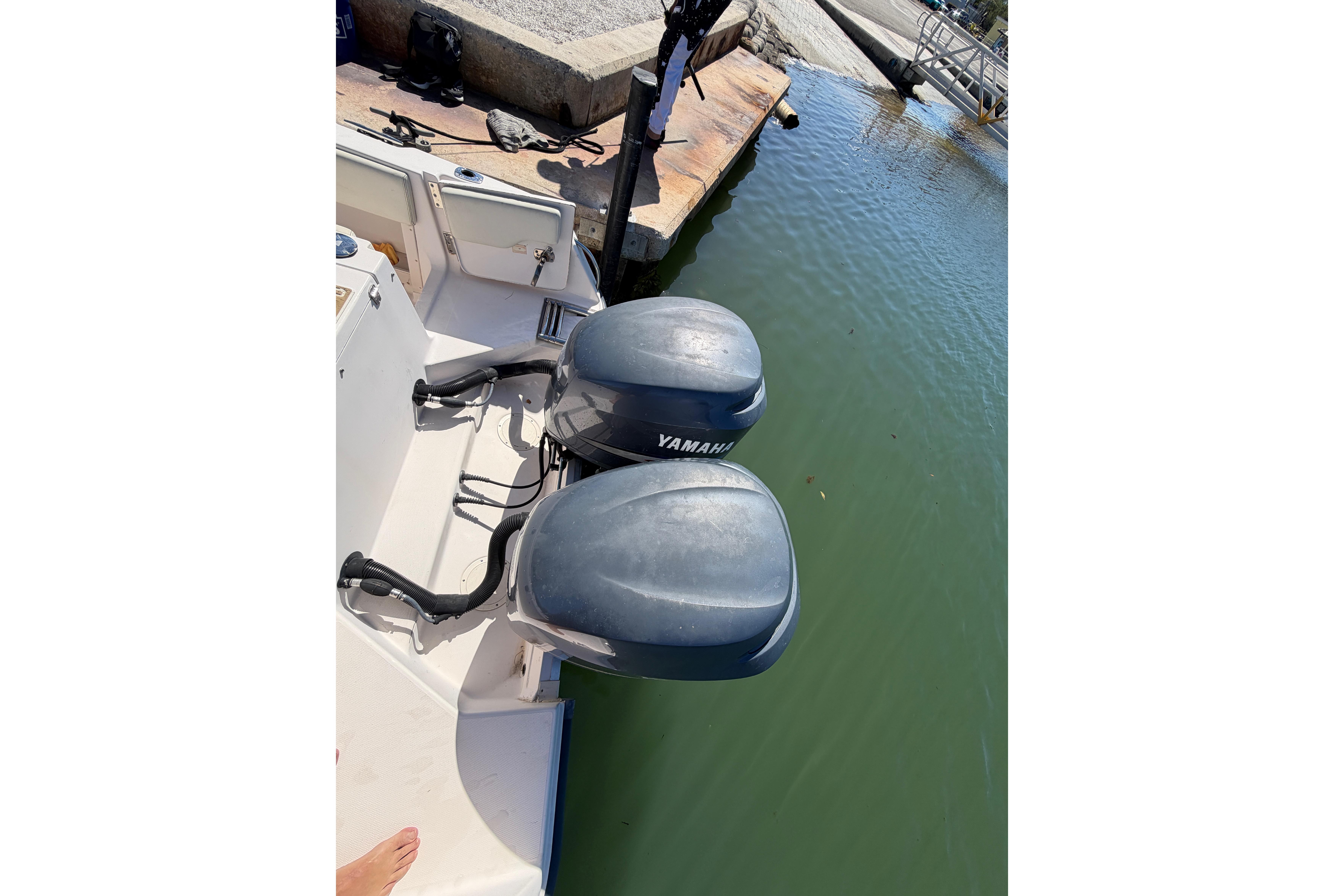 2006 Grady-White Sailfish 282 with dual Yamaha outboard motors docked by the water.