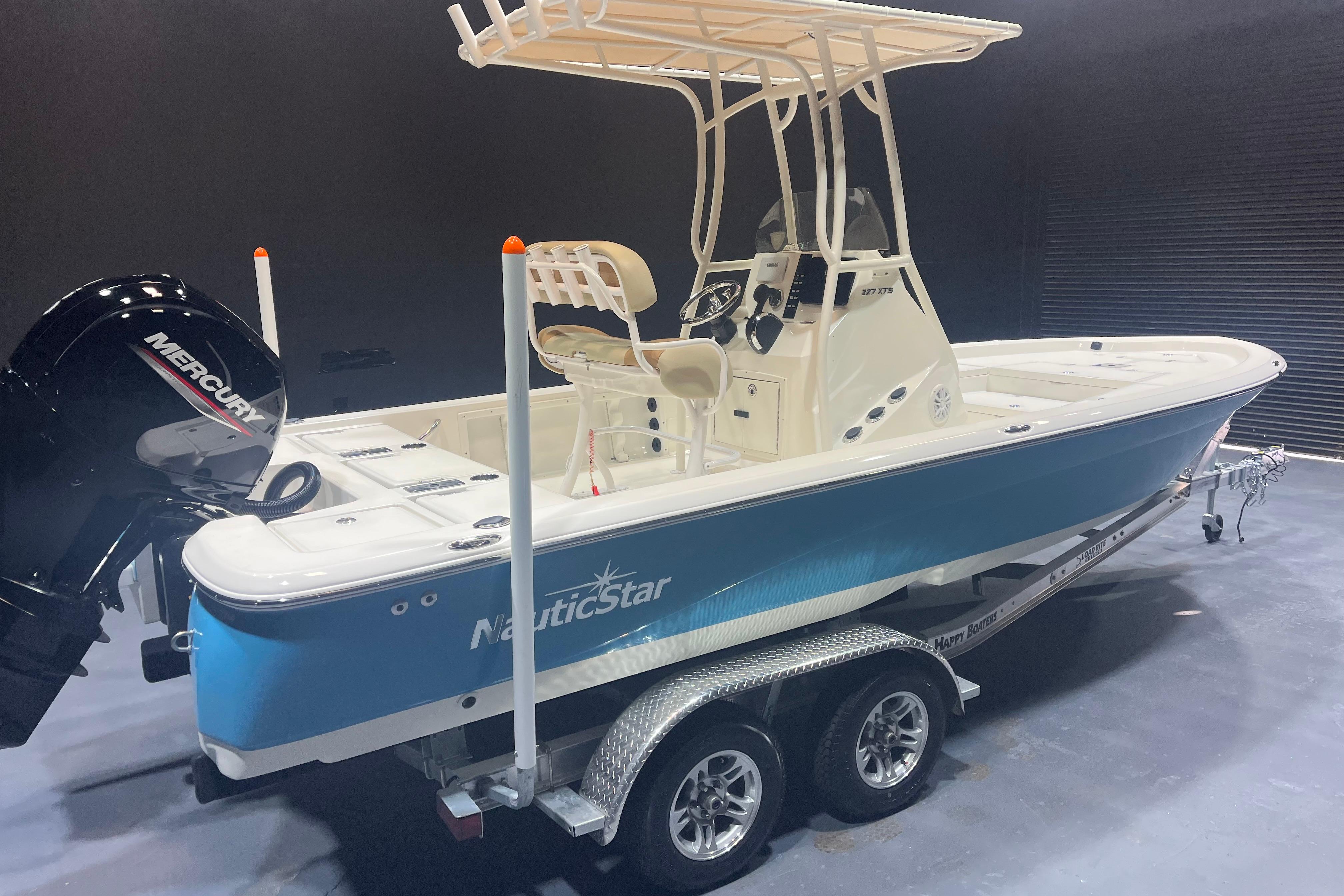 2023 NauticStar 227 XTS boat with Mercury engine on trailer.