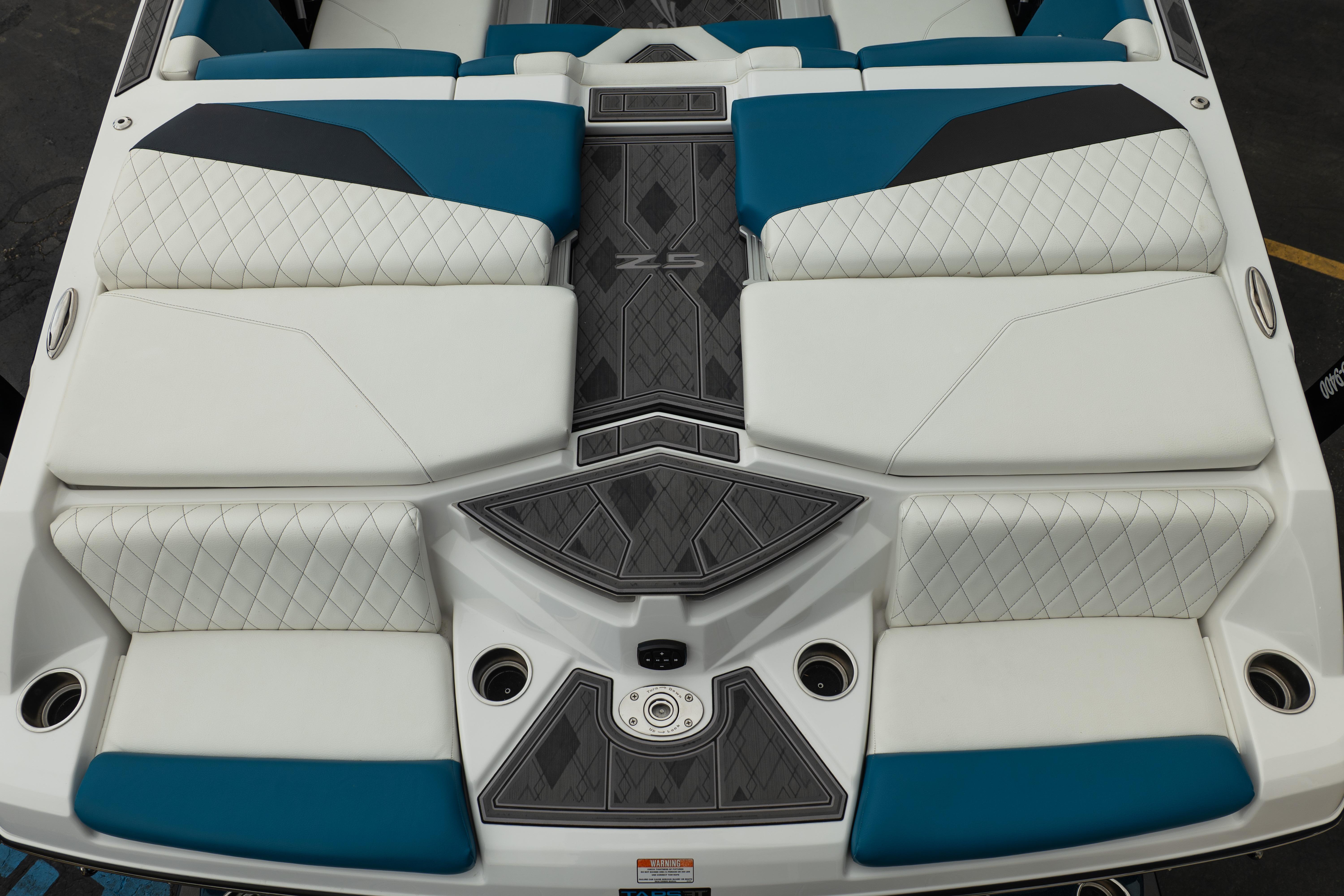 2024 Tigé Z5 boat interior with white and blue diamond-stitched seating and sleek design.