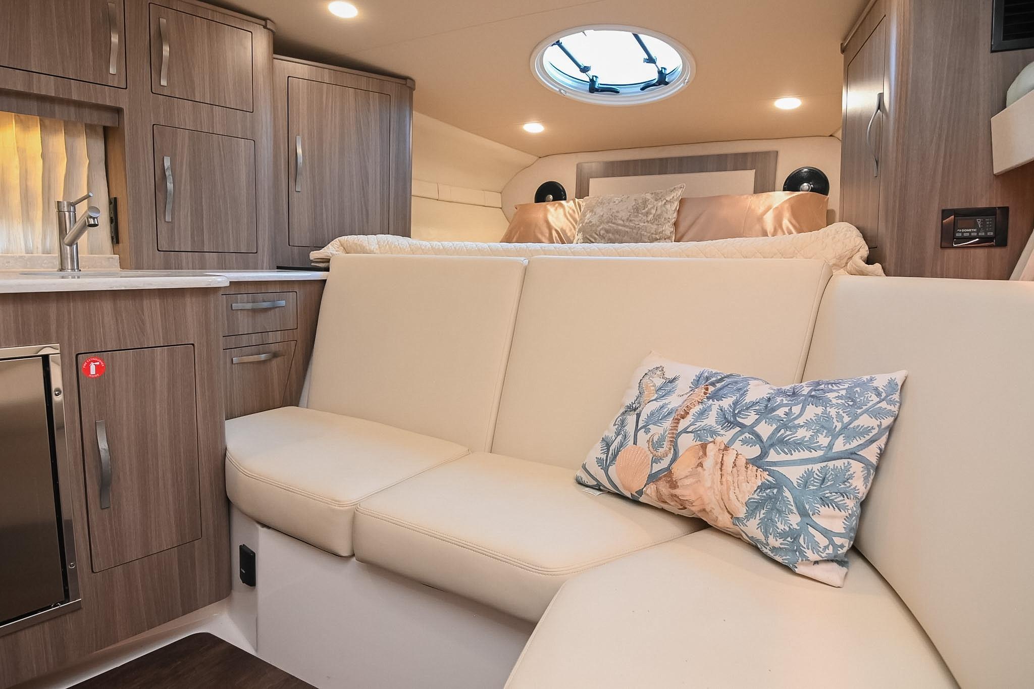 Interior of 2021 Regal 33 Express yacht with modern cabinetry and cozy seating area.