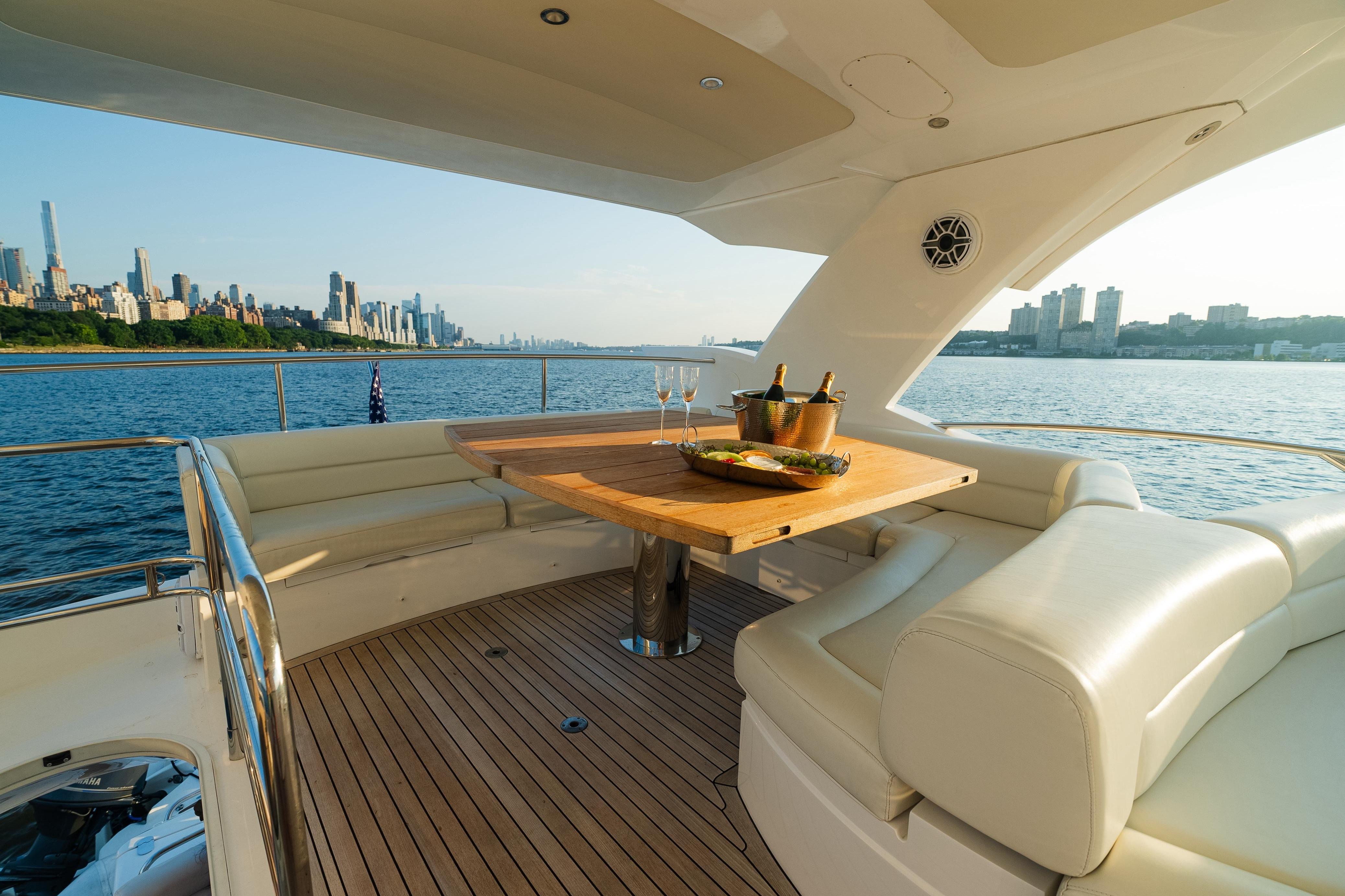 Luxurious 2016 Sunseeker Manhattan 65 yacht with elegant seating and city skyline view.