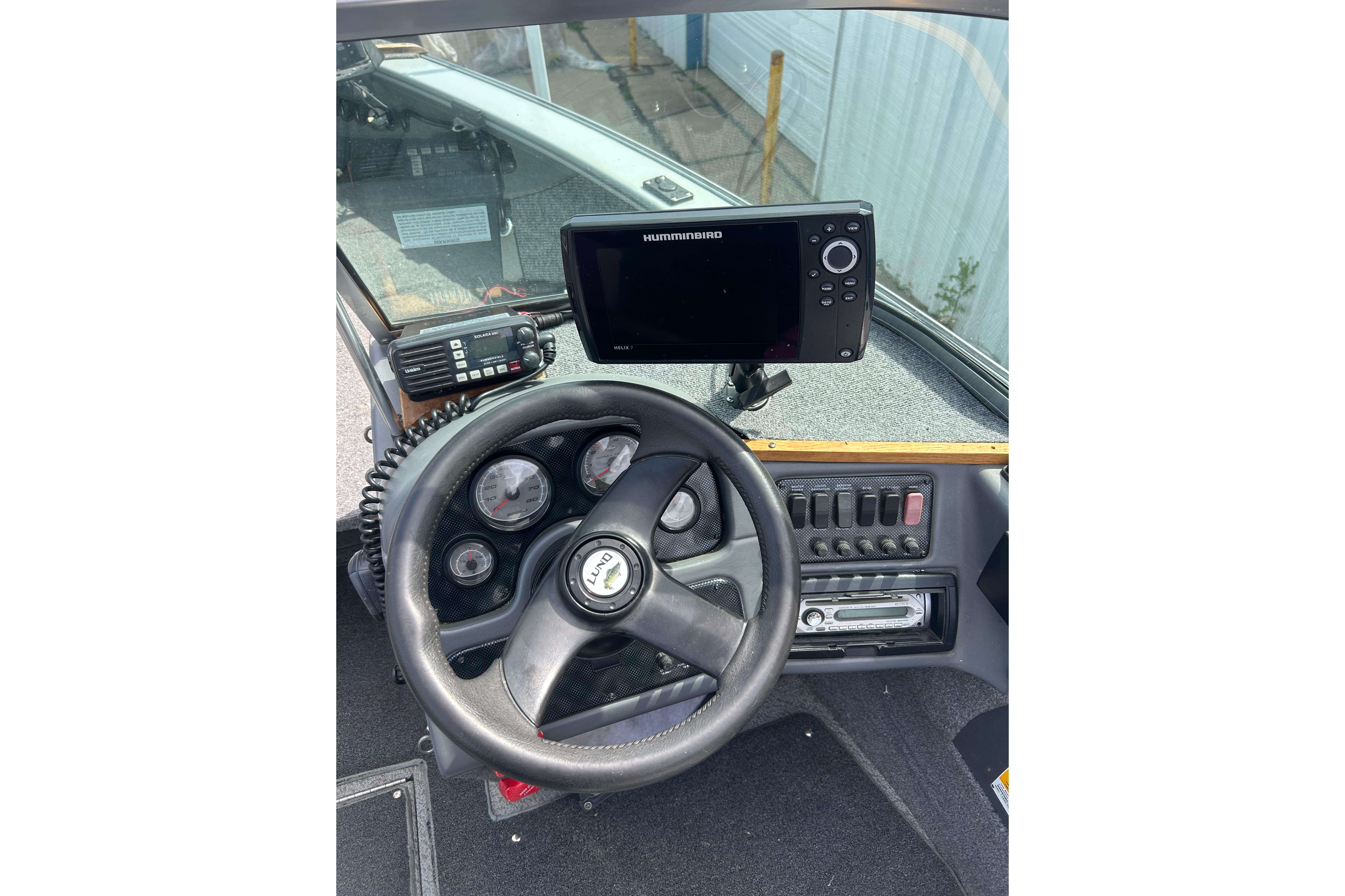 2008 Lund 1850 Fisherman dashboard with steering wheel, gauges, and Humminbird fish finder.