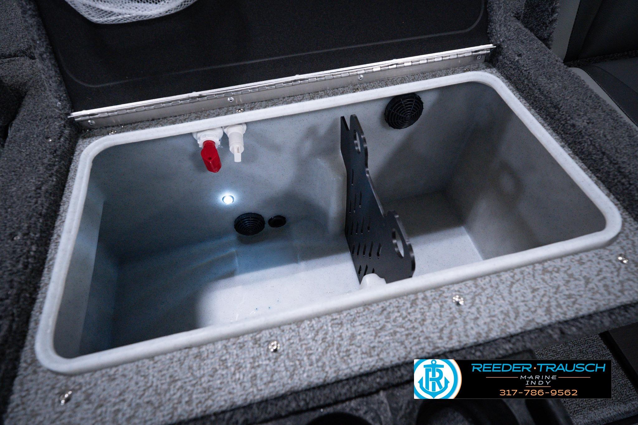 2026 Lund 1875 Impact XS SS boat livewell interior with plumbing and divider.