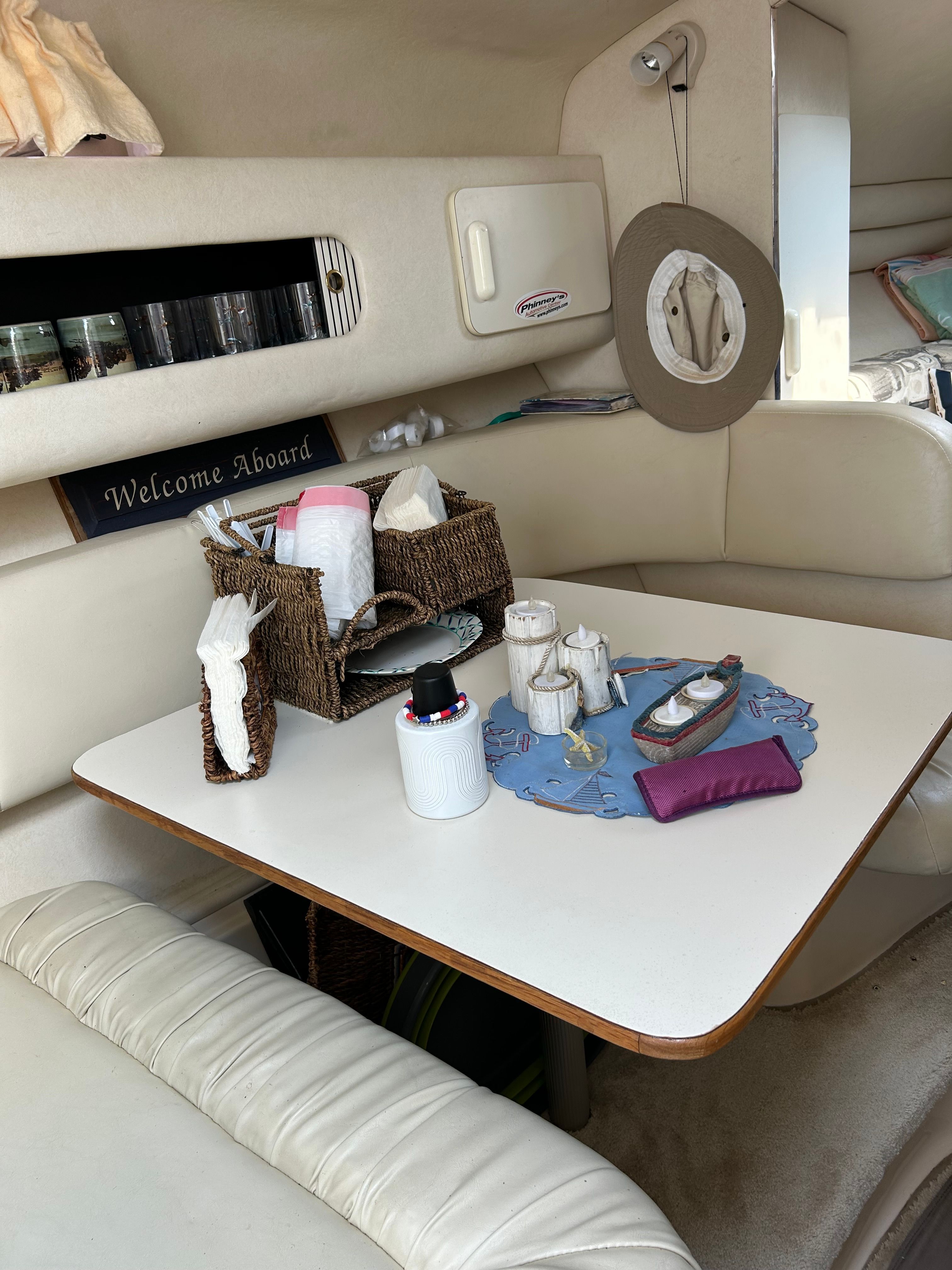 The interior of a 1999 Sea Ray 270 Sundancer with a table and seating area.