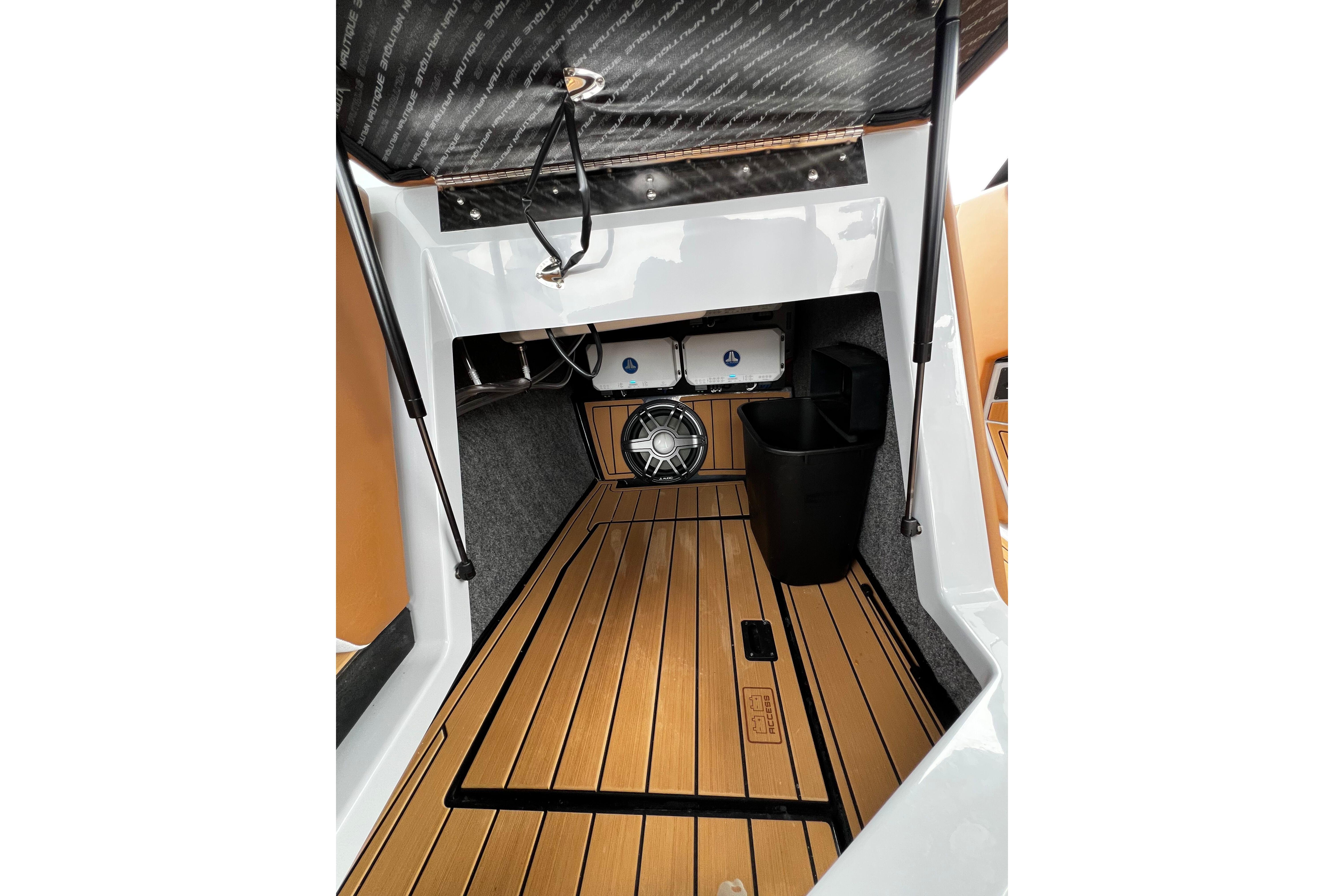 2026 Nautique Super Air Nautique G25 interior with teak flooring and modern audio system.
