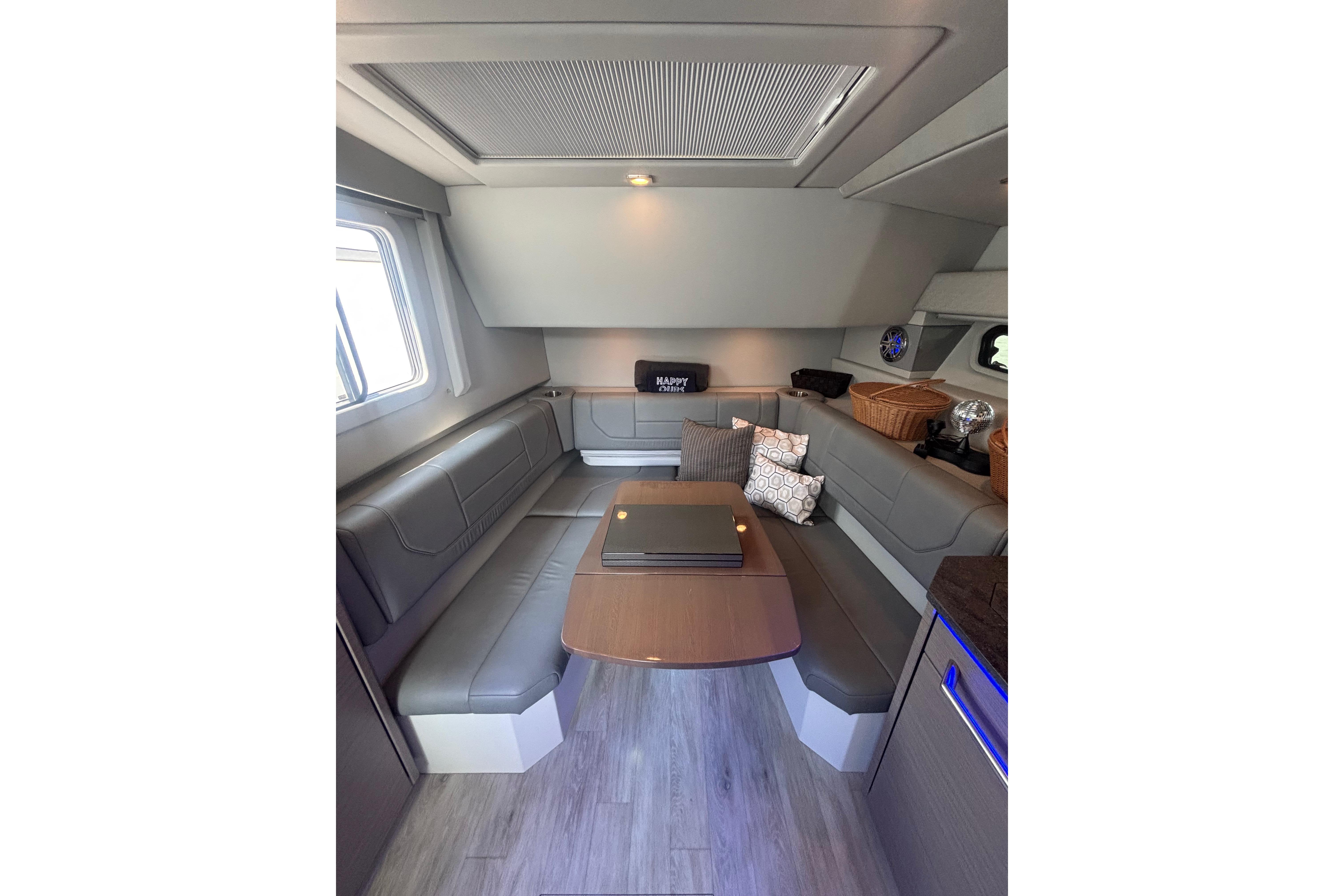 Interior of 2019 Formula 430 Super Sport Crossover with modern seating and table.