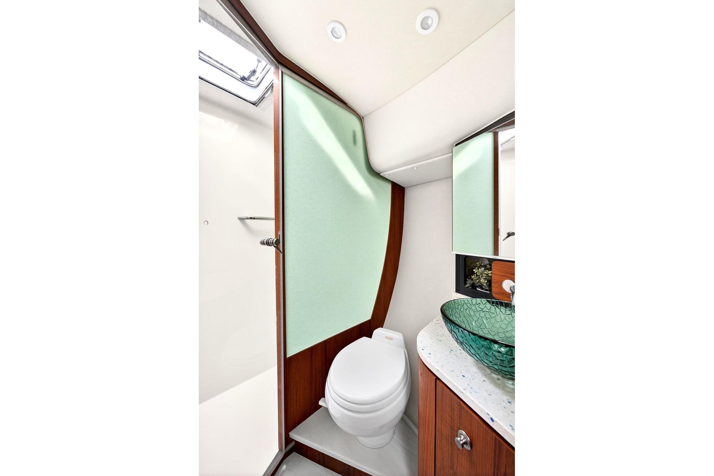 Luxurious bathroom in 2006 Tiara Yachts 4300 Sovran with modern fixtures and glass sink.