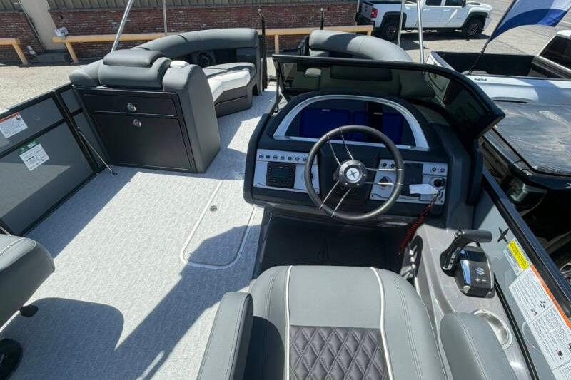 Interior view of 2026 Berkshire STS 23 Ultra Lounger SportArch boat, featuring modern helm and seating.
