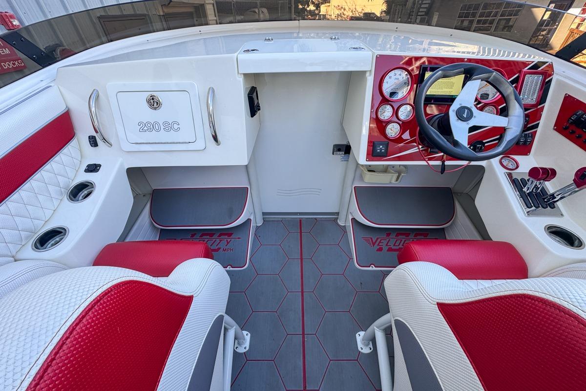 Cockpit of 2022 Velocity 290SC boat with red and white interior design.