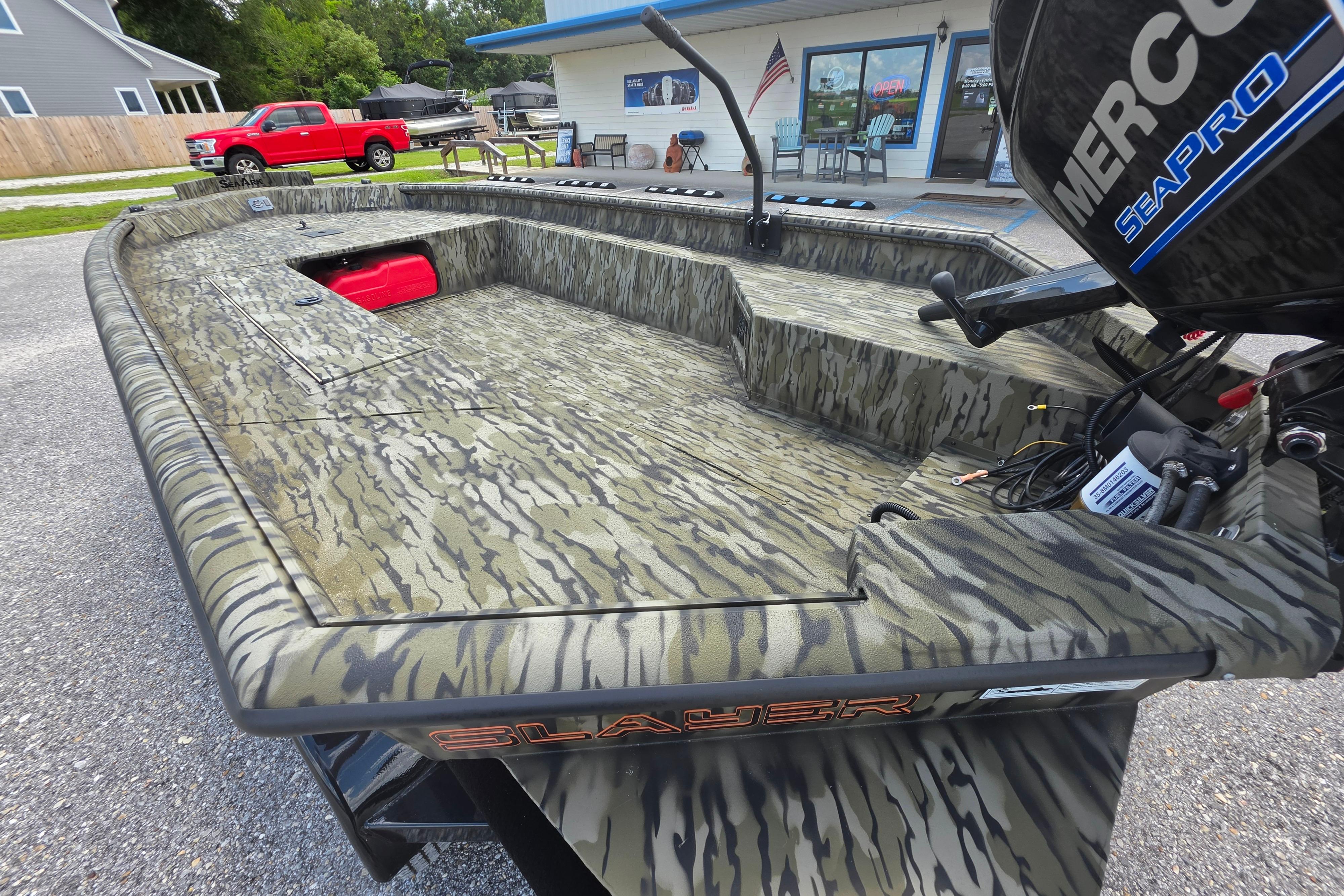 2025 SeaArk 1752 Slayer boat with camouflage design and Mercury SeaPro engine.