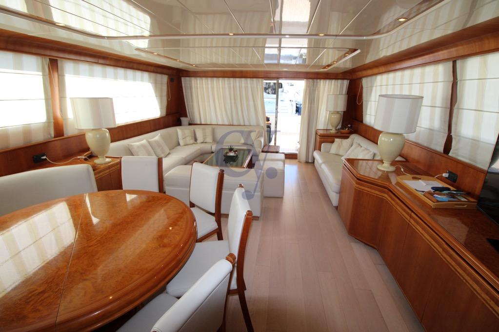 Luxurious interior of 1996 Canados 23 yacht with elegant wood and white furnishings.