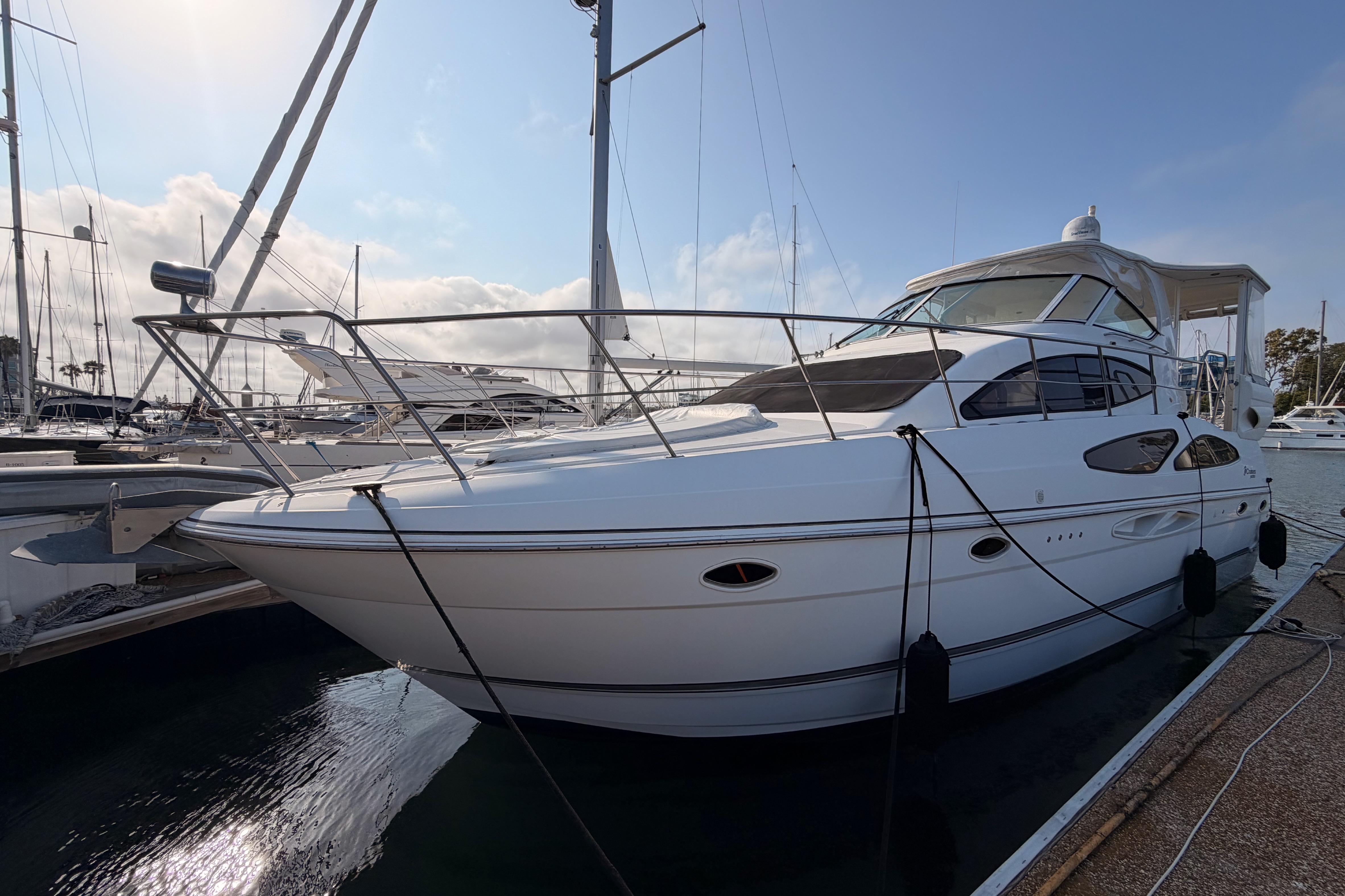 2005 Cruisers Yachts 405 Express Motoryacht docked at marina under clear sky.