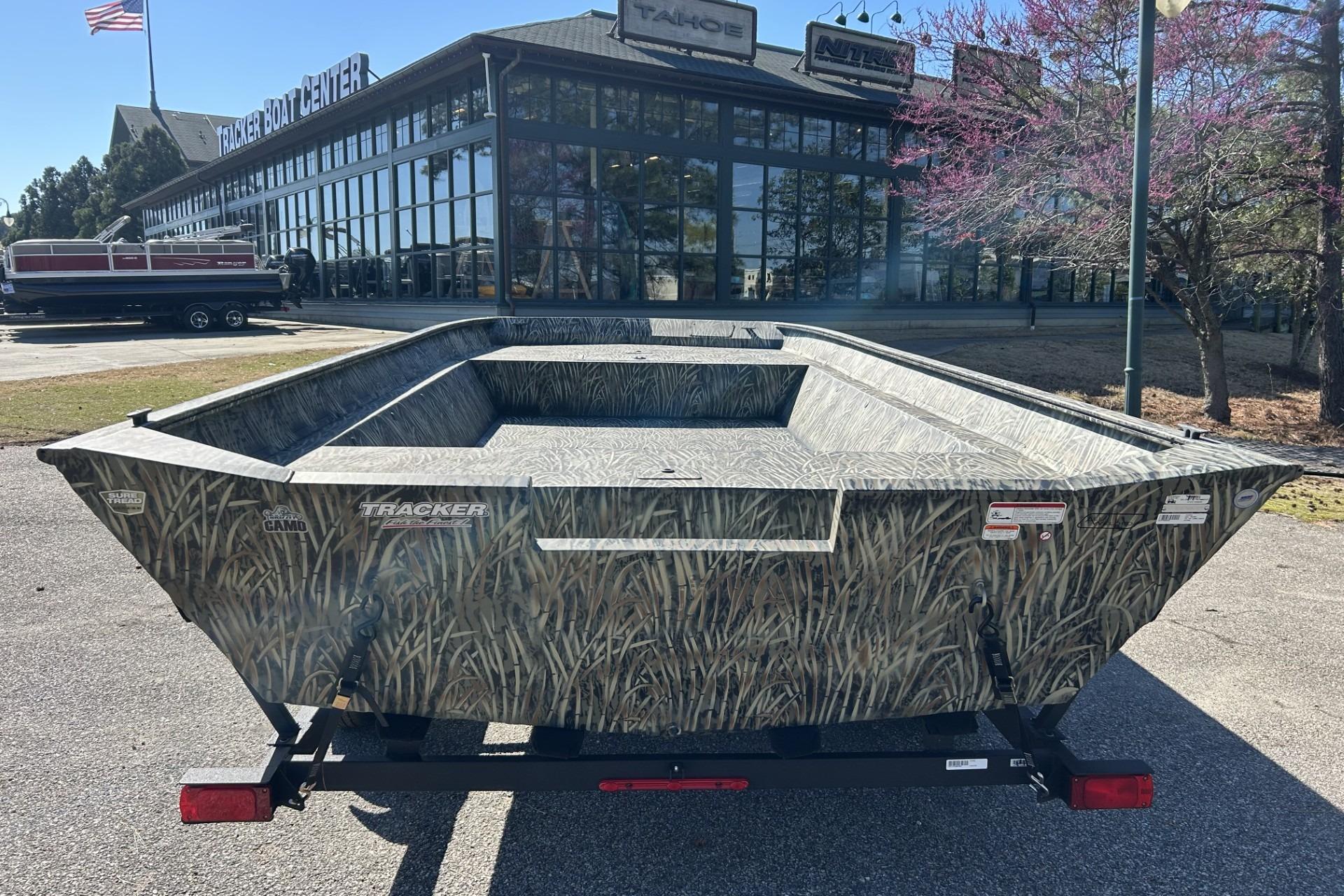 2025 Tracker Grizzly 2072 Utility boat with camo design at dealership.