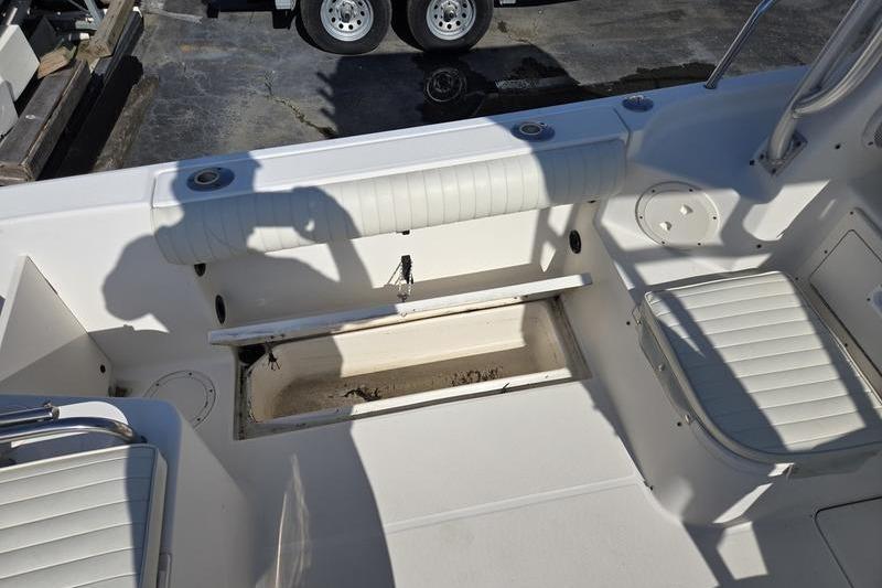 2004 Robalo R235 Walkaround boat interior with seating and storage compartment.